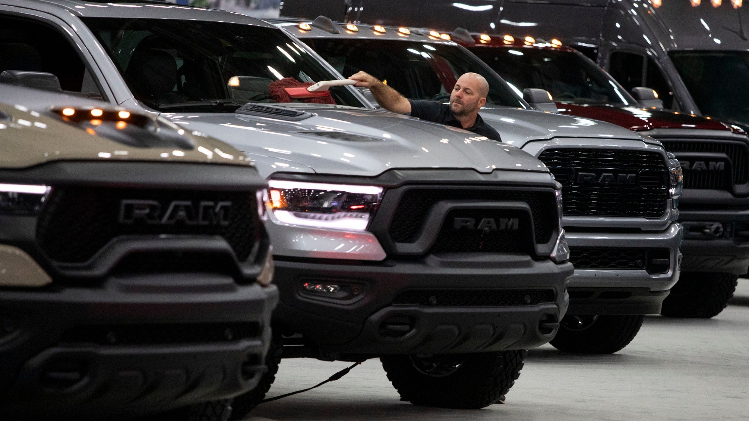 DETROIT, MI - SEPTEMBER 14: A worker cleans a RAM truck at the 2022 North American International Auto Show on September 14, 2022 in Detroit, Michigan.The NAIAS opens to the public on September 17 and features the latest state of the art electric vehicles, vehicle rides, the world’s first battery-powered Monster Truck, an Air Mobility Experience featuring flight demonstrations of jet suits, hoverboards, and vertical take-off and landing aircraft, a Dinosaur Encounter featuring 80 life-like and life-size dinosaurs, and the world’s largest rubber duck. (Photo by Bill Pugliano/Getty Images)