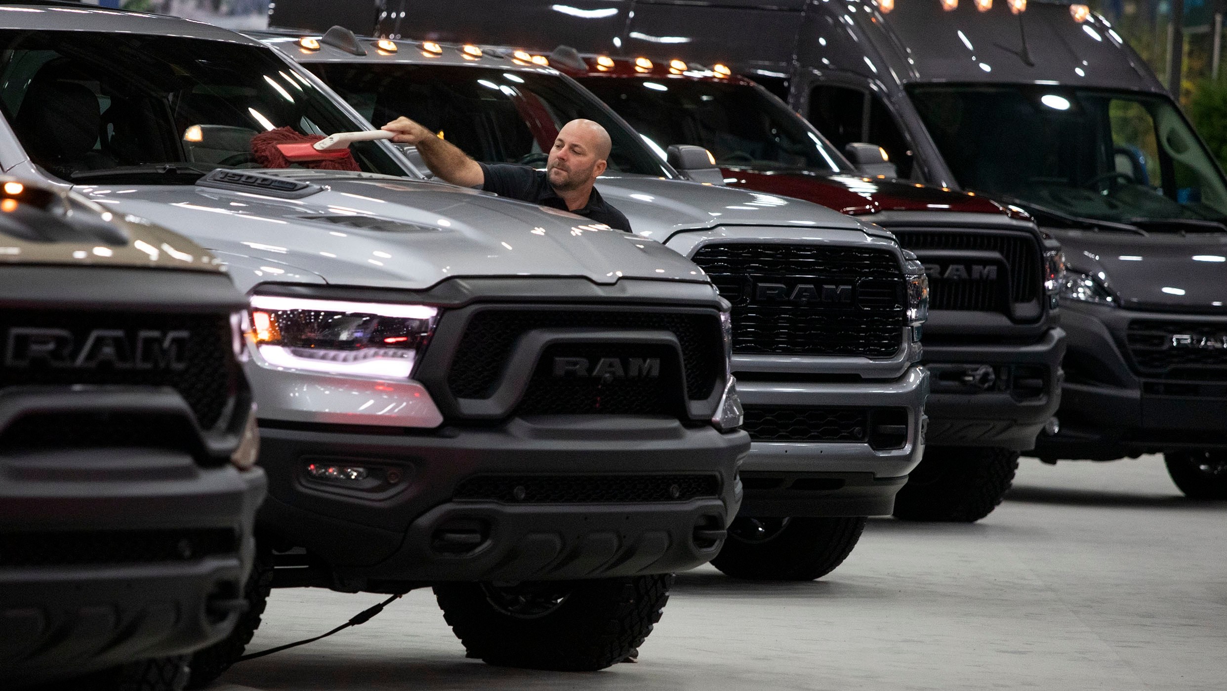 DETROIT, MI - SEPTEMBER 14: A worker cleans a RAM truck at the 2022 North American International Auto Show on September 14, 2022 in Detroit, Michigan.The NAIAS opens to the public on September 17 and features the latest state of the art electric vehicles, vehicle rides, the world’s first battery-powered Monster Truck, an Air Mobility Experience featuring flight demonstrations of jet suits, hoverboards, and vertical take-off and landing aircraft, a Dinosaur Encounter featuring 80 life-like and life-size dinosaurs, and the world’s largest rubber duck. (Photo by Bill Pugliano/Getty Images)