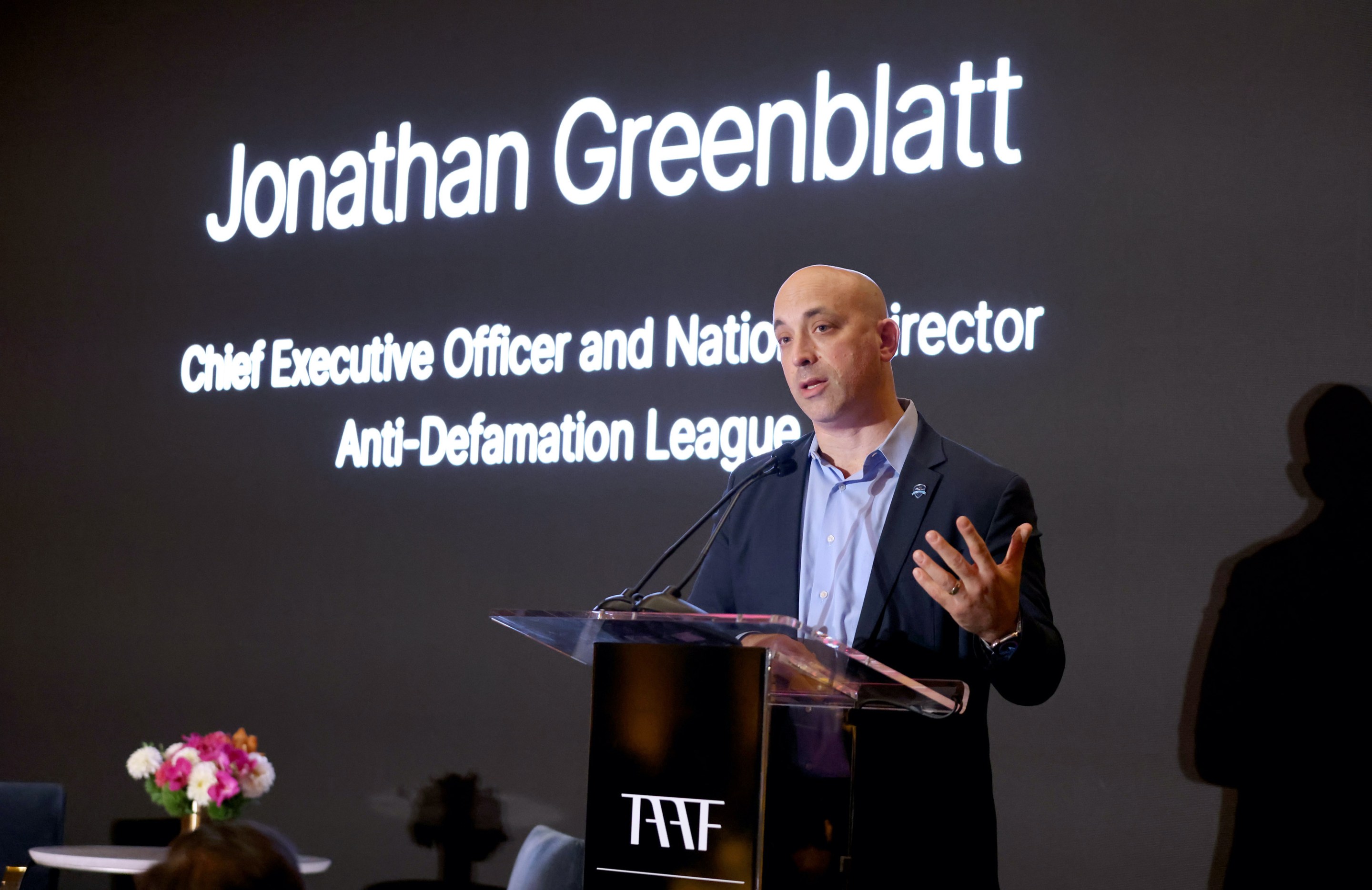 Jonathan Greenblatt of the ADL speaking at a dinner.