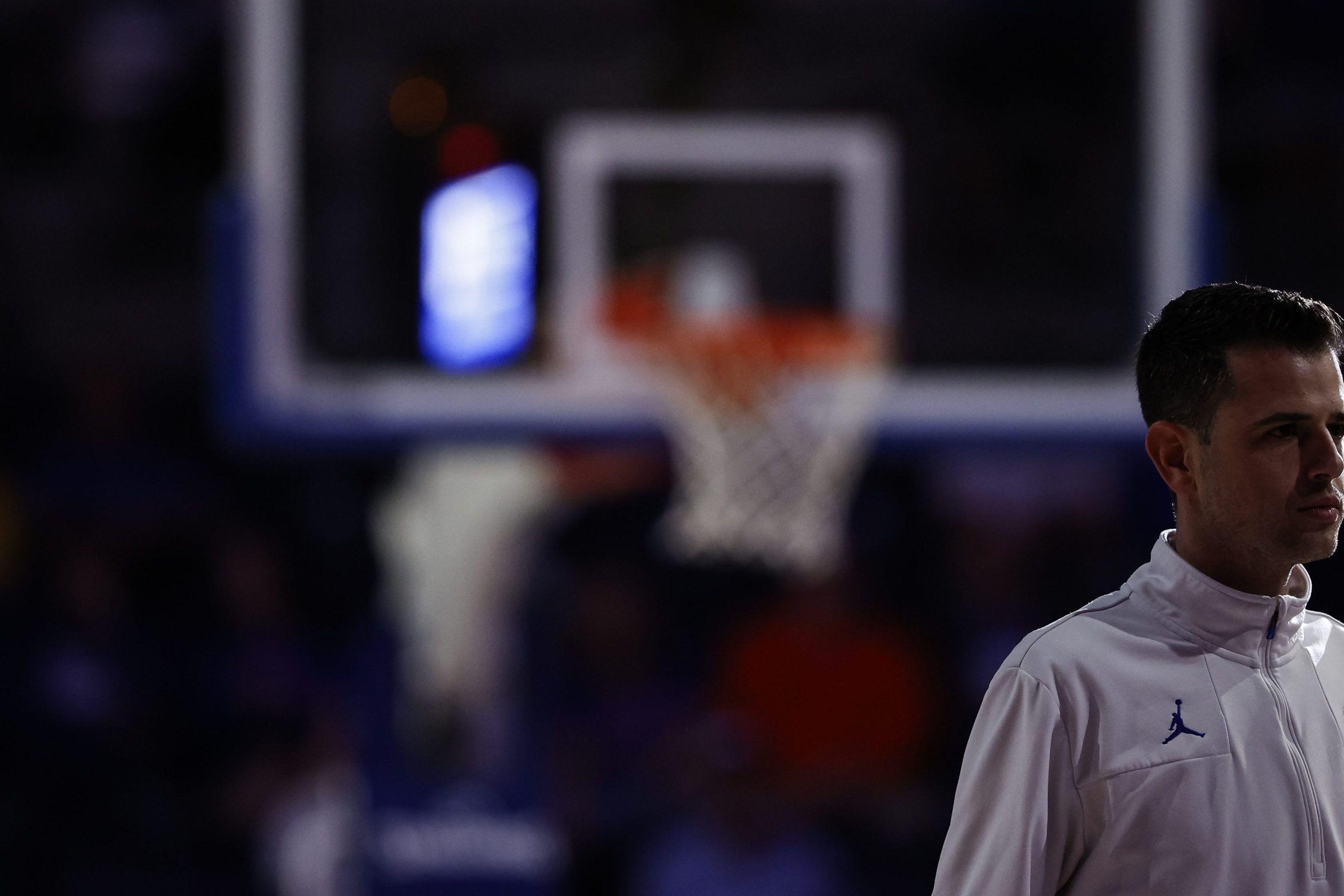 Florida coach Todd Golden standing in front of a basketball hoop.