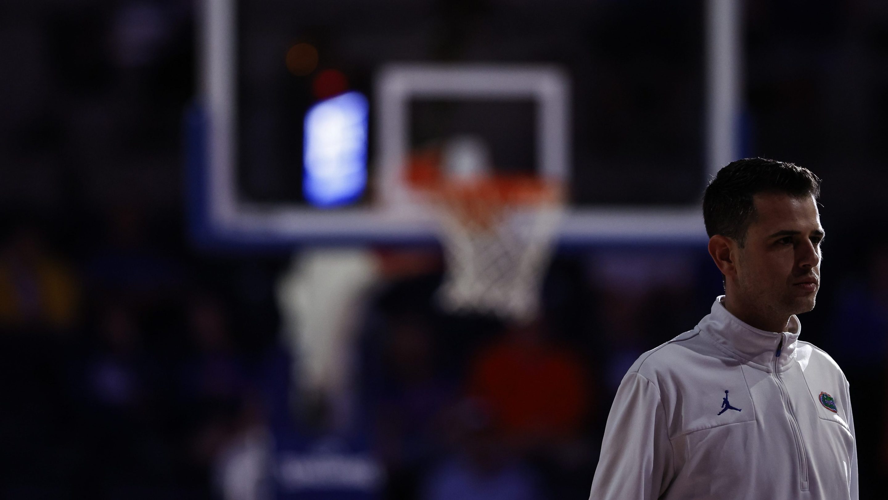 Florida coach Todd Golden standing in front of a basketball hoop.