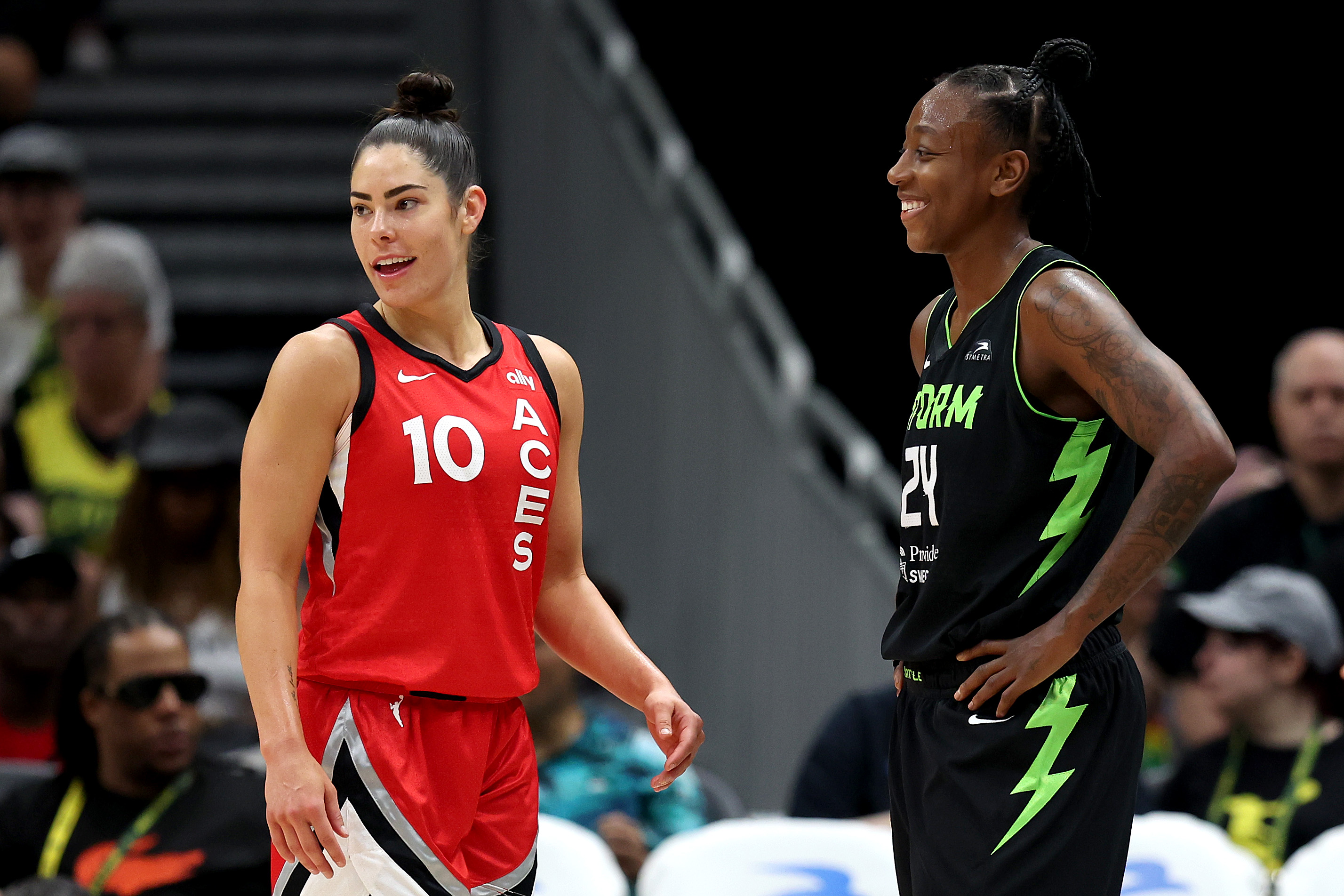 Kelsey Plum #10 of the Las Vegas Aces and Jewell Loyd #24 of the Seattle Storm look on during the fourth quarter at Climate Pledge Arena on July 10, 2024 in Seattle, Washington.