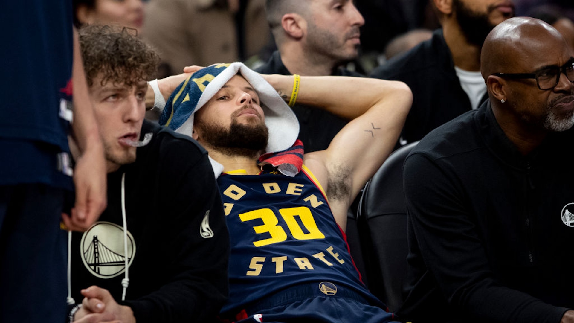 Golden State Warriors guard Stephen Curry (30) is seen on the bench during the second half of his NBA basketball game against the Miami Heat in San Francisco, Tuesday, Jan. 7, 2025. The Heat defeated the Wariors 114-98.