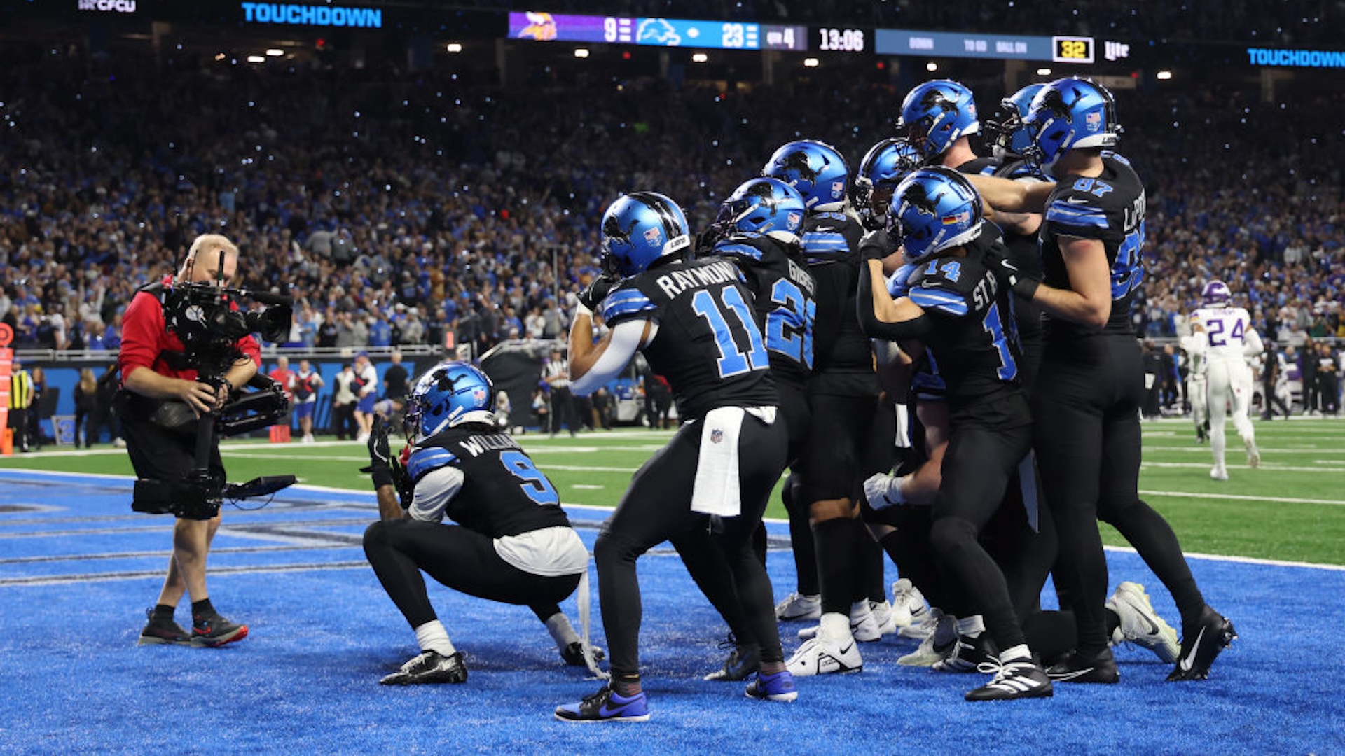 DETROIT, MICHIGAN - JANUARY 05: Jahmyr Gibbs #26 of the Detroit Lions celebrates a touchdown with teammates during the fourth quarter against the Minnesota Vikings at Ford Field on January 05, 2025 in Detroit, Michigan.