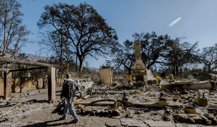 A man surveys the charred remains of his home, destroyed in the Eaton Fire, on Jan. 8. The house, built in 1902 and owned by his family for generations, was slated for a remodel to pass down to the next generation. Now, with the fire's devastation, he is uncertain if he will rebuild or return to the property. The Eaton Fire, fueled by Santa Ana winds, has burnt over 13,000 acres and has destroyed over 5,000 homes and businesses.