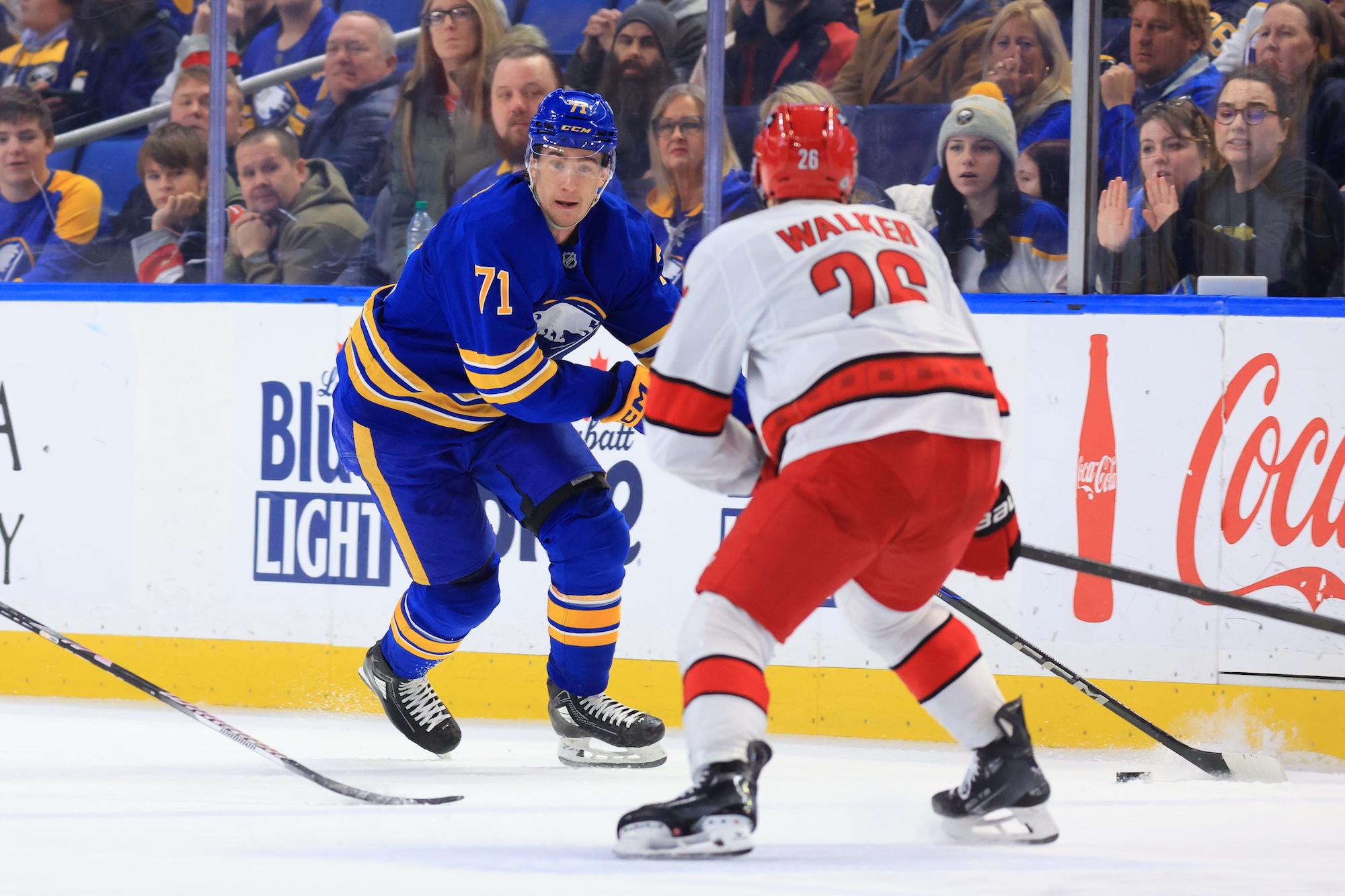 BUFFALO, NEW YORK - JANUARY 15: Ryan McLeod #71 of the Buffalo Sabres skates with the puck against Sean Walker #26 of the Carolina Hurricanes during an NHL game on January 15, 2025 at KeyBank Center in Buffalo, New York. (Photo by Bill Wippert/NHLI via Getty Images)