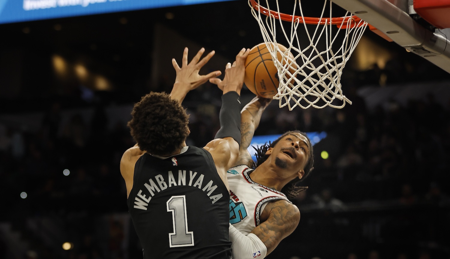 SAN ANTONIO, TX - JANUARY 15: Ja Morant #12 of the Memphis Grizzlies tries to dunk over Victor Wembanyama #1 of the San Antonio Spurs in the second half at Frost Bank Center on January 15, 2025 in San Antonio, Texas. NOTE TO USER: User expressly acknowledges and agrees that, by downloading and or using this photograph, User is consenting to terms and conditions of the Getty Images License Agreement. (Photo by Ronald Cortes/Getty Images)