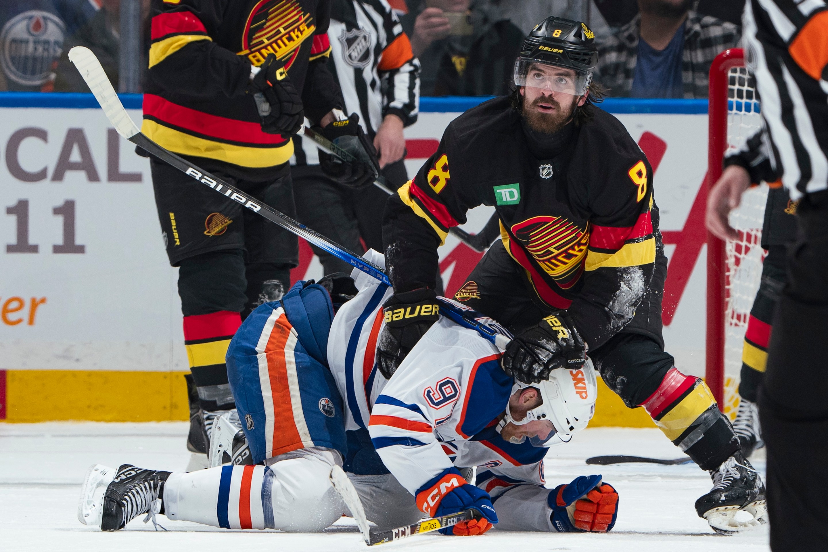 VANCOUVER, CANADA - JANUARY 18: Conor Garland #8 of the Vancouver Canucks checks Connor McDavid #97 of the Edmonton Oilers during the third period of their NHL game at Rogers Arena on January 18, 2025 in Vancouver, British Columbia, Canada. Vancouver won 3-2. (Photo by Jeff Vinnick/NHLI via Getty Images)