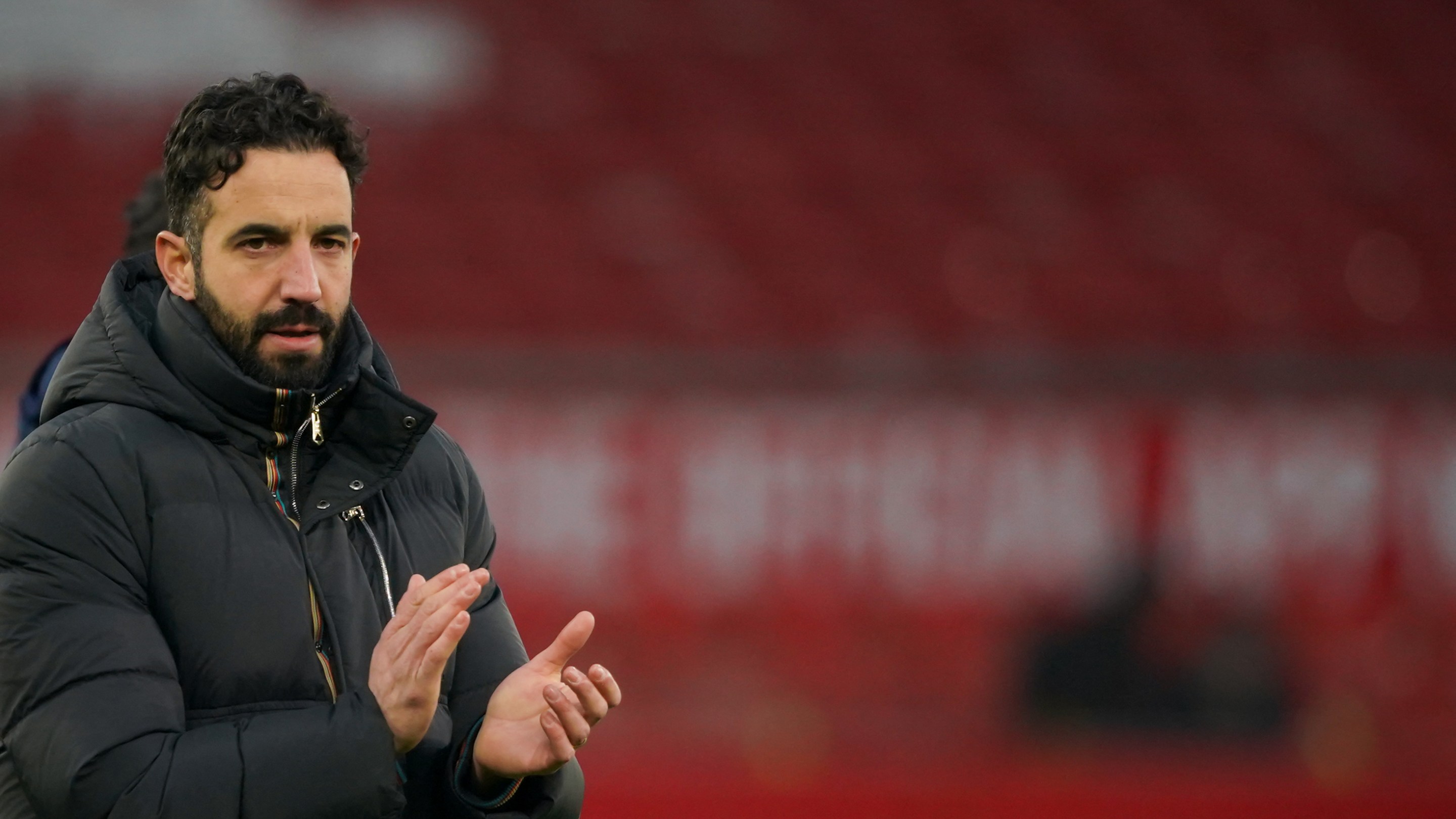 Manchester United's Portuguese head coach Ruben Amorim applauds at the end of the English Premier League football match between Manchester United and Brighton and Hove Albion at Old Trafford in Manchester. He looks pretty sad.