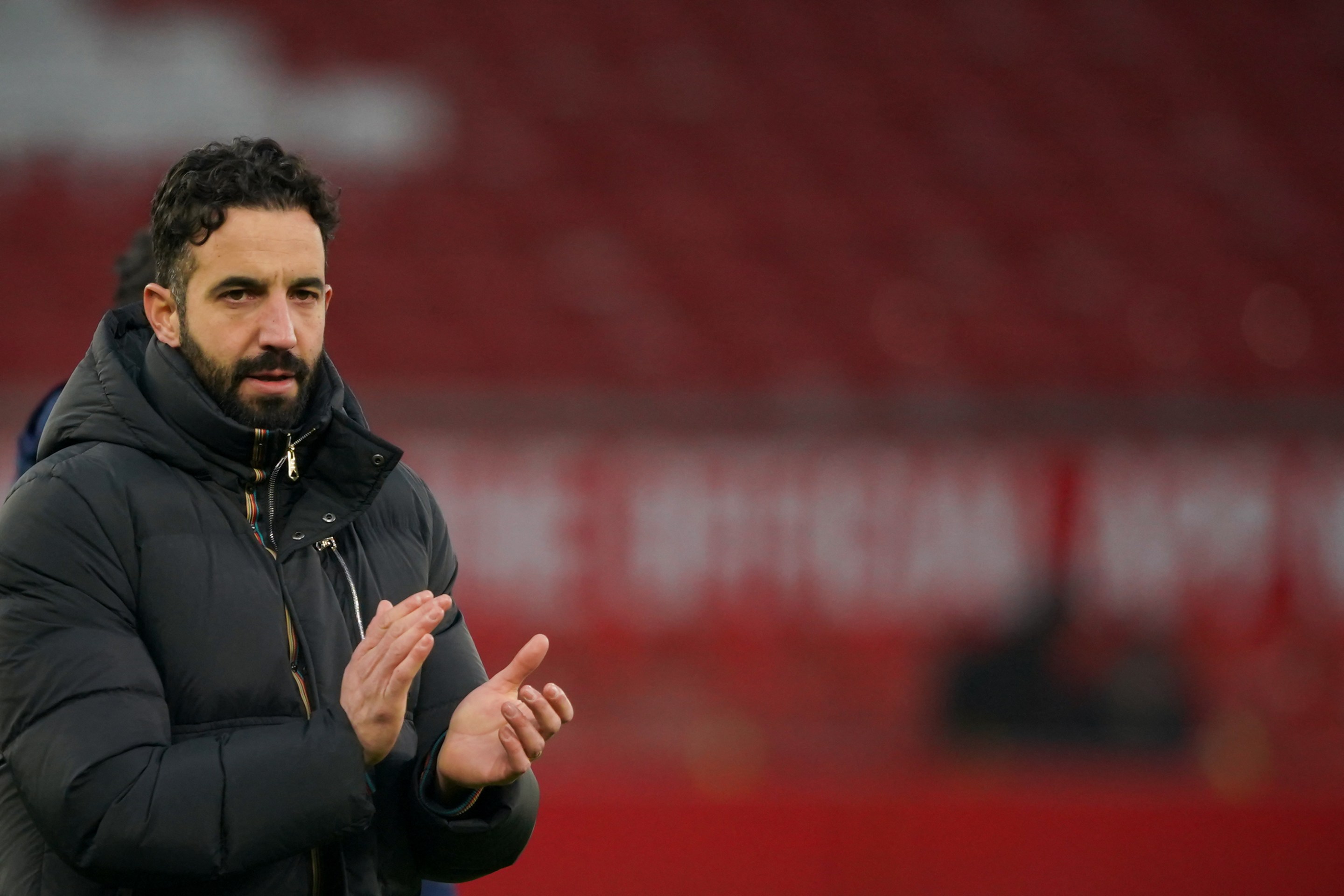 Manchester United's Portuguese head coach Ruben Amorim applauds at the end of the English Premier League football match between Manchester United and Brighton and Hove Albion at Old Trafford in Manchester. He looks pretty sad.