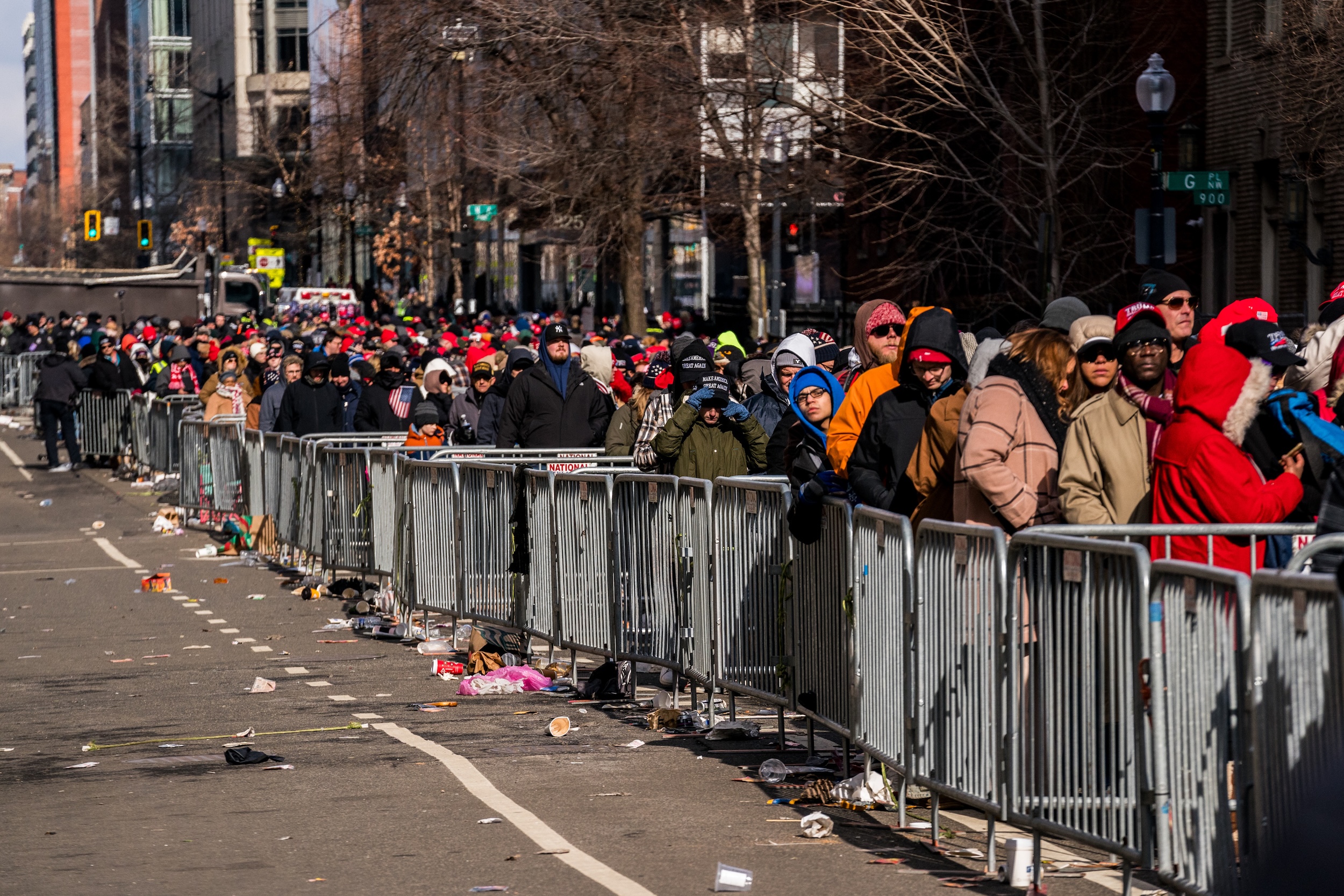 Trump supporters crowd the parade route, with trash everywhere.