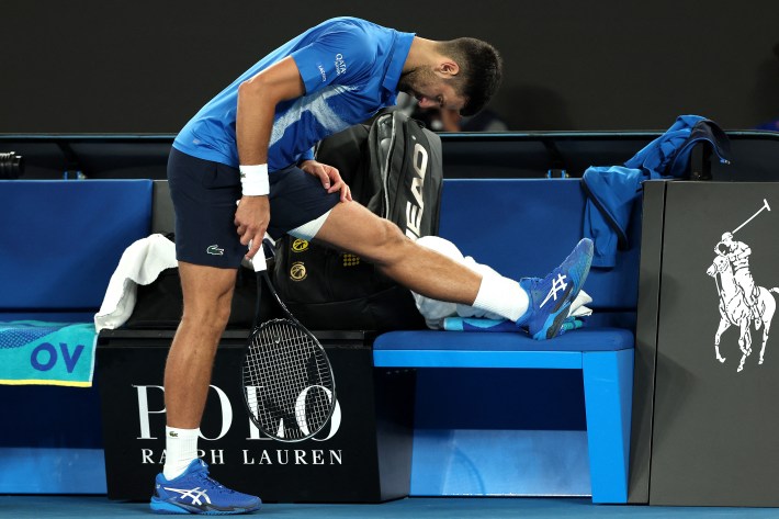 Novak Djokovic stretches out his leg during a match against Carlos Alcaraz.