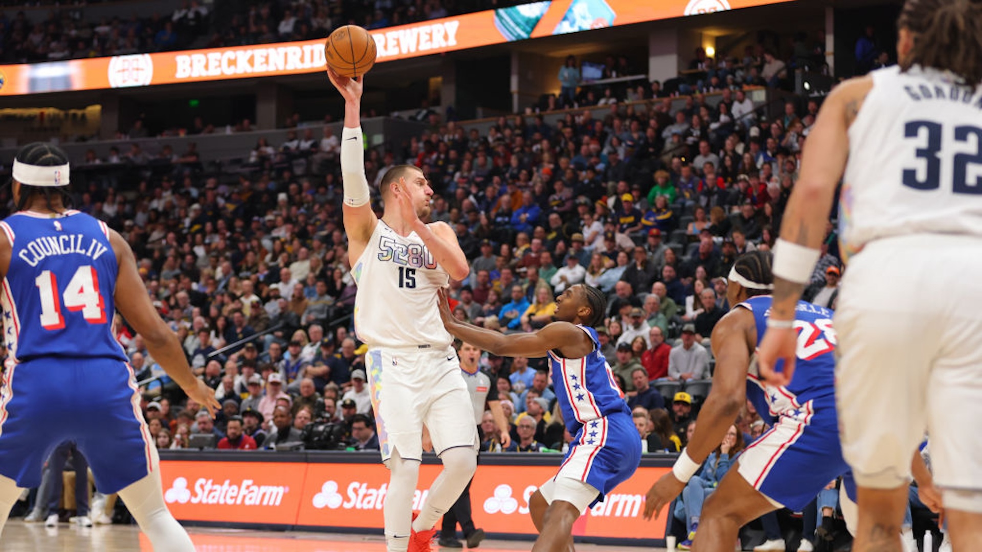 DENVER, COLORADO - JANUARY 21: Nikola Jokic #15 of the Denver Nuggets throws a no-look alley-oop pass to Aaron Gordon #32 against the Philadelphia 76ers during the third quarter at Ball Arena on January 21, 2025 in Denver, Colorado. NOTE TO USER: User expressly acknowledges and agrees that, by downloading and or using this photograph, User is consenting to the terms and conditions of the Getty Images License Agreement.