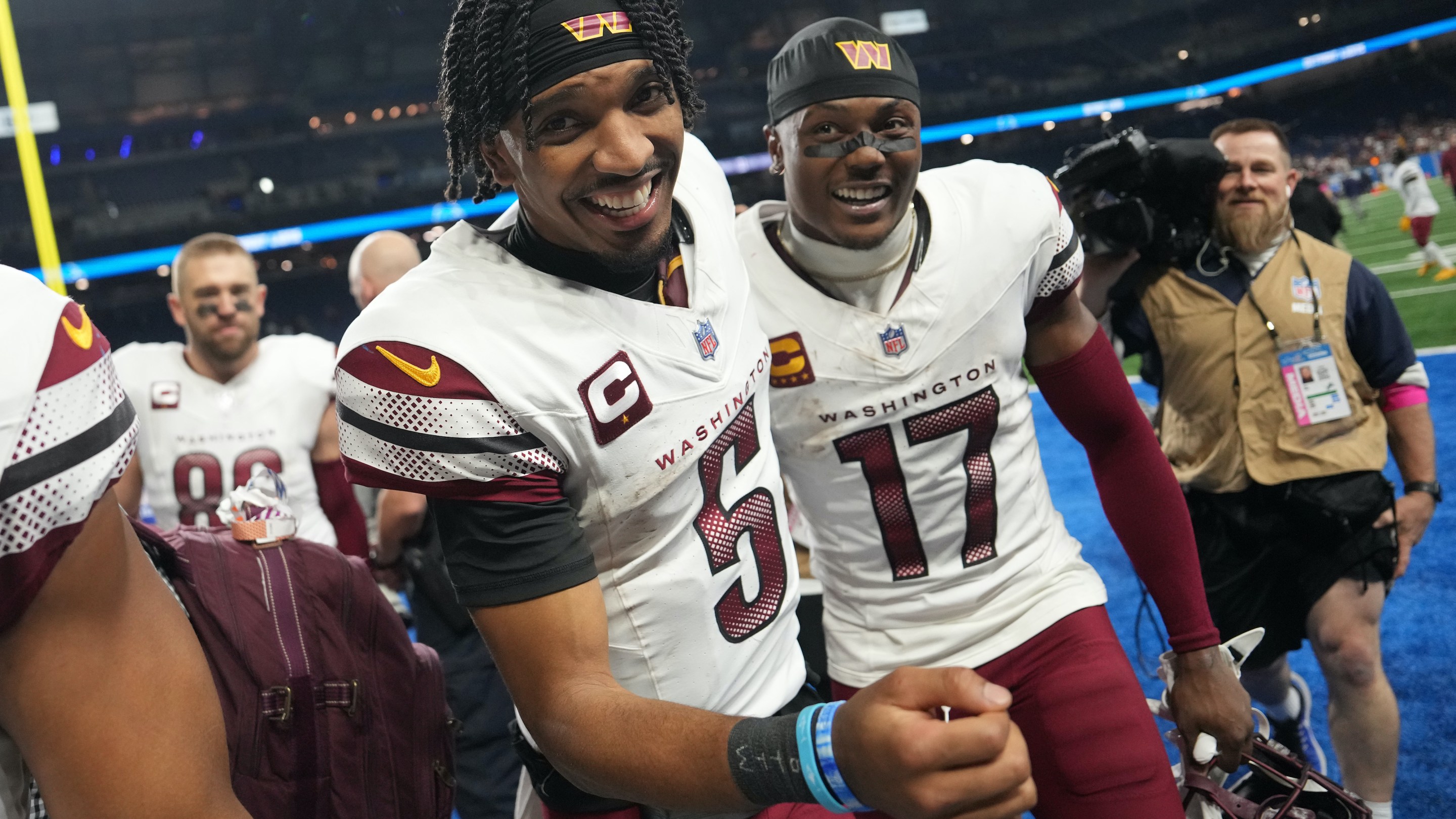 Jayden Daniels and Terry McLaurin smile after beating the Lions in the divisional round.