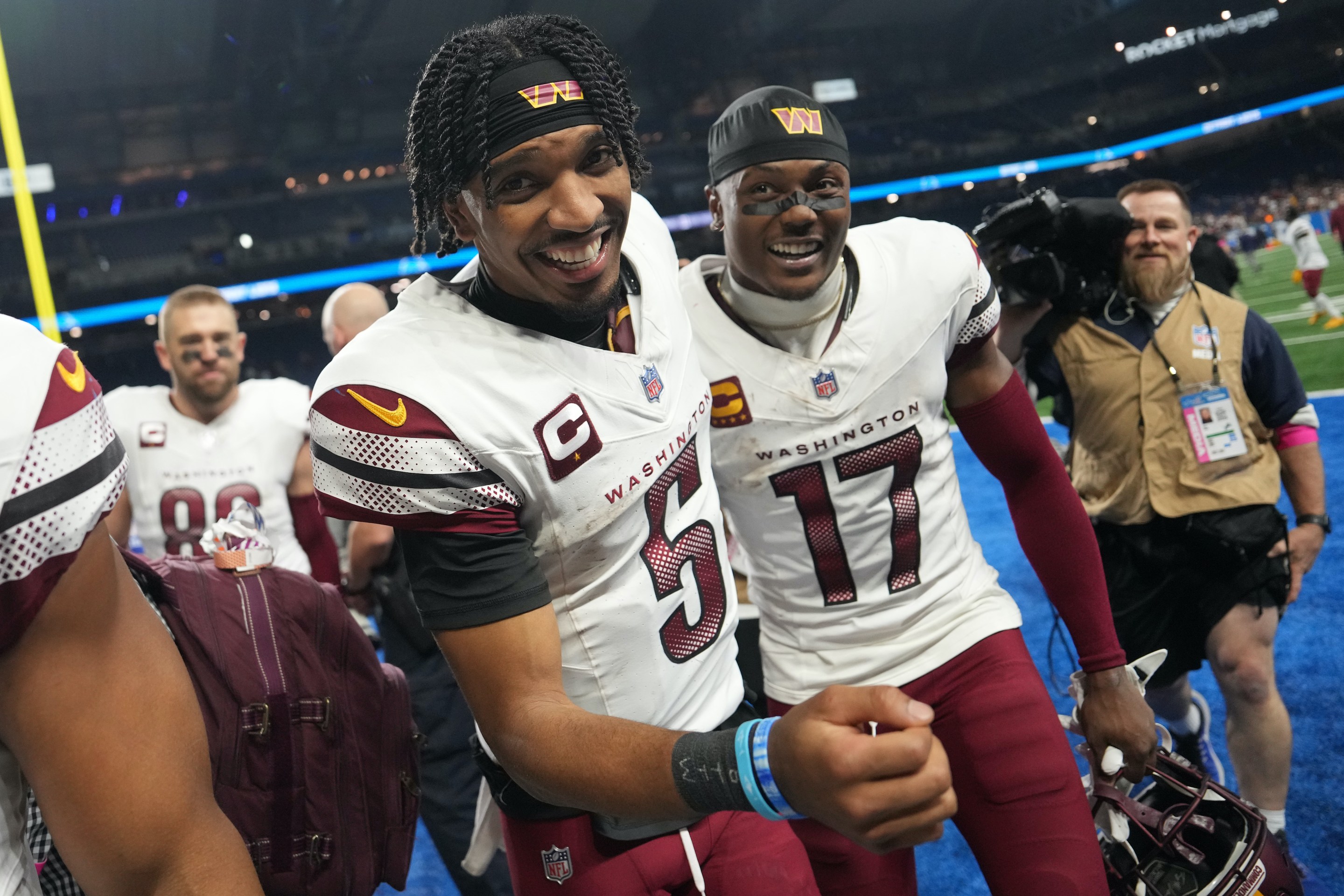 Jayden Daniels and Terry McLaurin smile after beating the Lions in the divisional round.