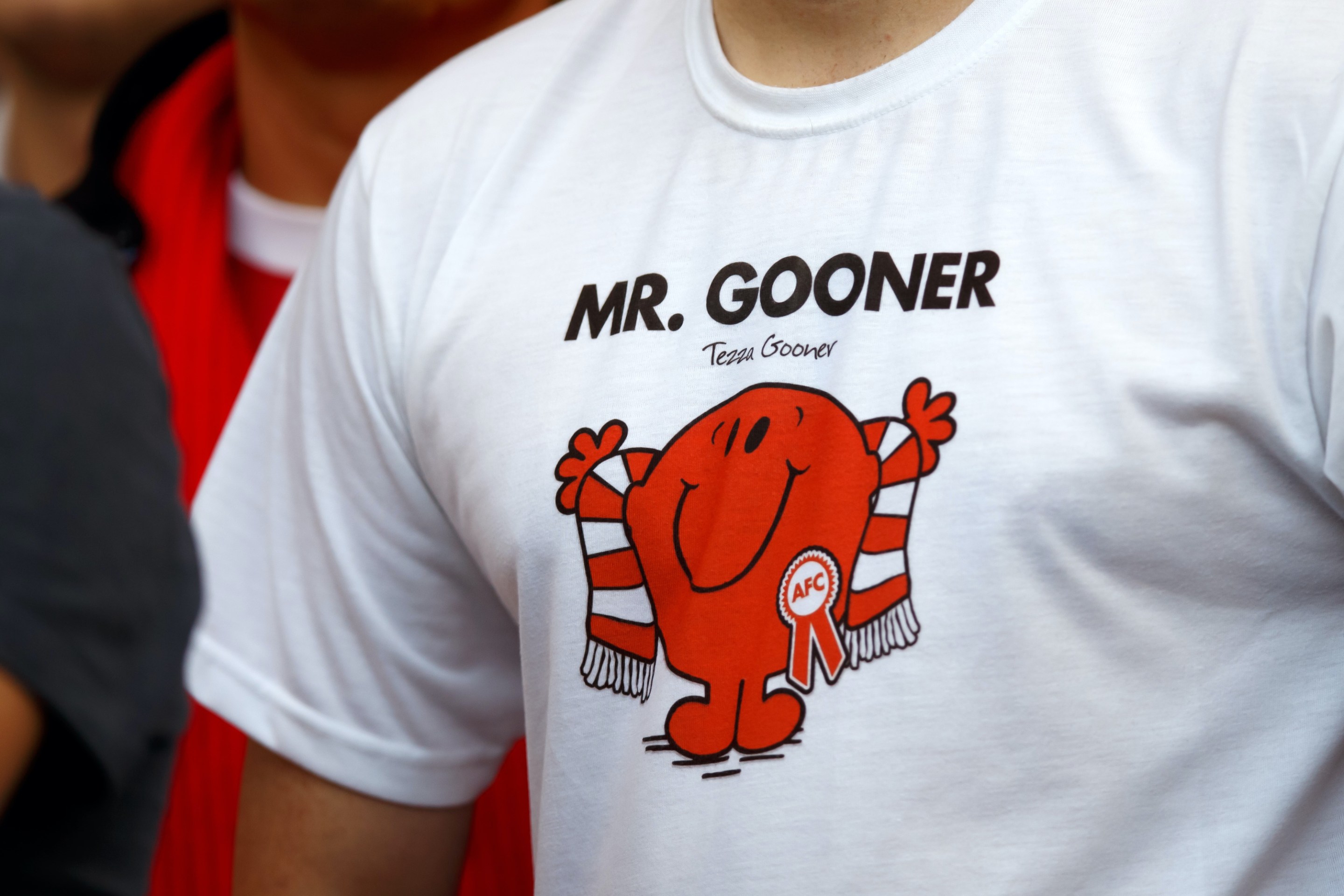 An Arsenal fan wearing a shirt that reads "Mr. Gooner"