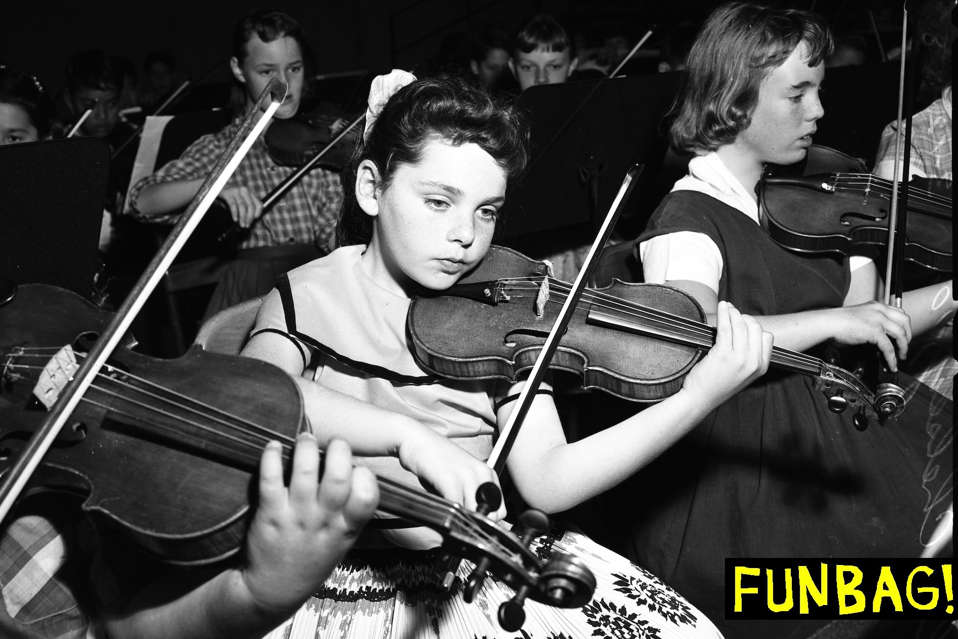 Leslie Chelsey, 10, of Victory Boulevard School, plays violin. (Photo by USC Libraries/Corbis via Getty Images)