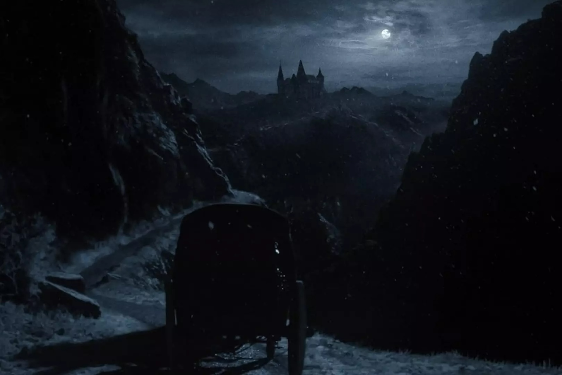 An image of a carriage approaching a moonlit castle, from Nosferatu