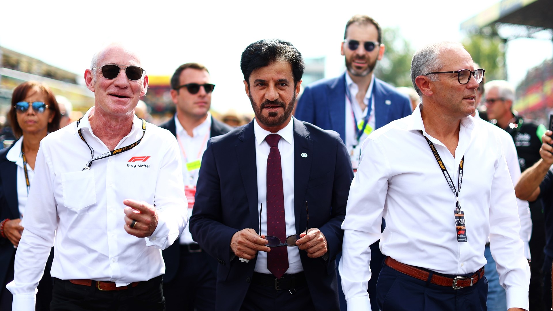 Greg Maffei, CEO of Liberty Media, Mohammed ben Sulayem, FIA President, and Stefano Domenicali, CEO of the Formula One Group, walk on the grid during the F1 Grand Prix of Italy.