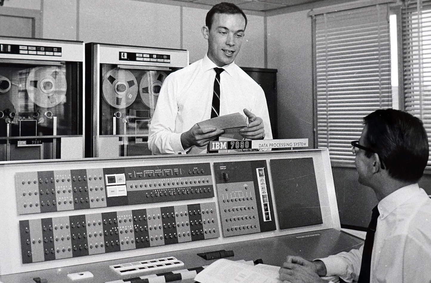 A black-and-white image of some nerds doing computing and codebreaking at an IBM 7090 Data Processing System in the early 1960s.