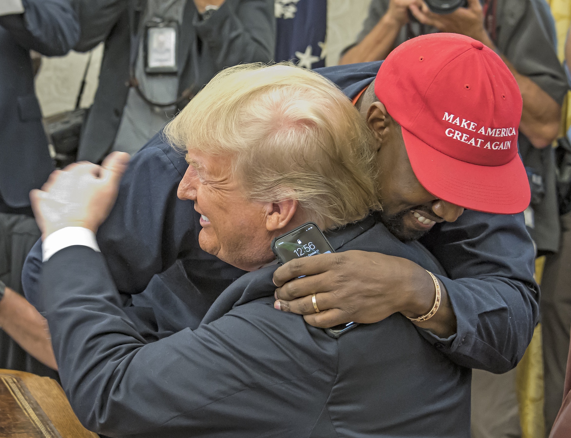 Kanye West and Donald Trump hugging.