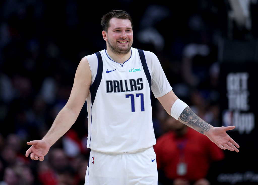 A photo of Dallas Mavericks player Luka Doncic shurgging on court during a game