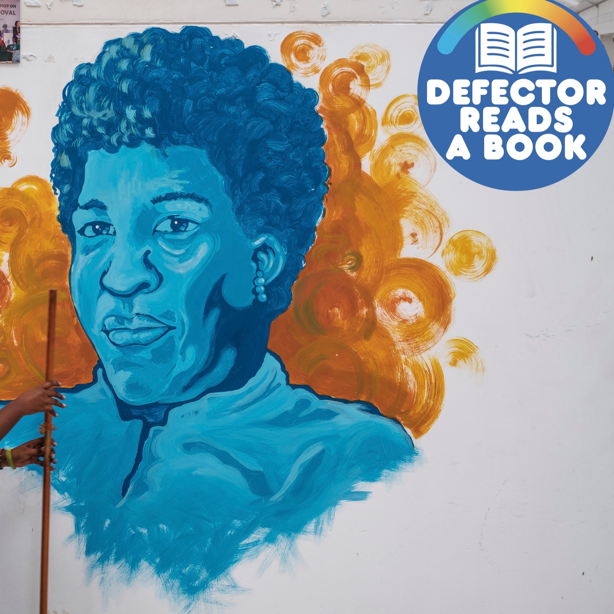 A woman walks in front of a mural depicting writer Octavia Butler in Nairobi, Kenya. The Defector Reads A Book badge is at upper right.