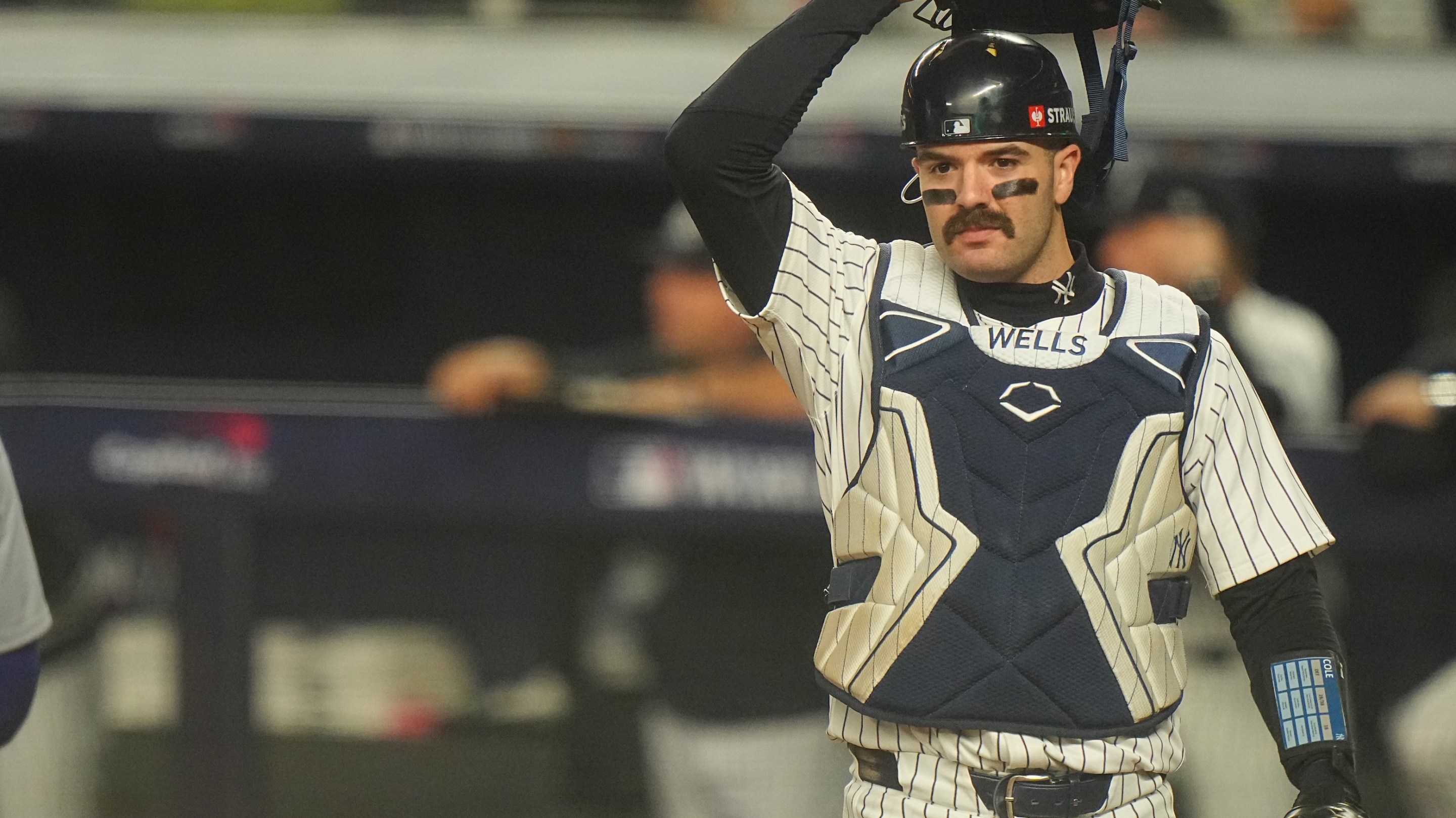 Austin Wells in action, looks on from behind the plate vs Los Angeles Dodgers at Yankee Stadium. Game 5. Big ol mustache on his upper lip.