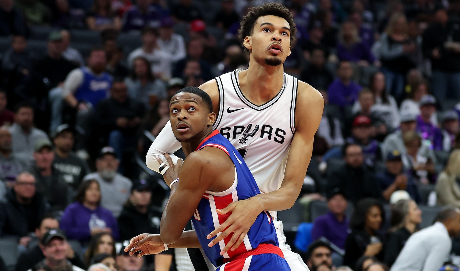 SACRAMENTO, CALIFORNIA - DECEMBER 01: Victor Wembanyama #1 of the San Antonio Spurs and De'Aaron Fox #5 of the Sacramento Kings go for a rebound in the first half at Golden 1 Center on December 01, 2024 in Sacramento, California. NOTE TO USER: User expressly acknowledges and agrees that, by downloading and/or using this photograph, user is consenting to the terms and conditions of the Getty Images License Agreement. (Photo by Ezra Shaw/Getty Images)