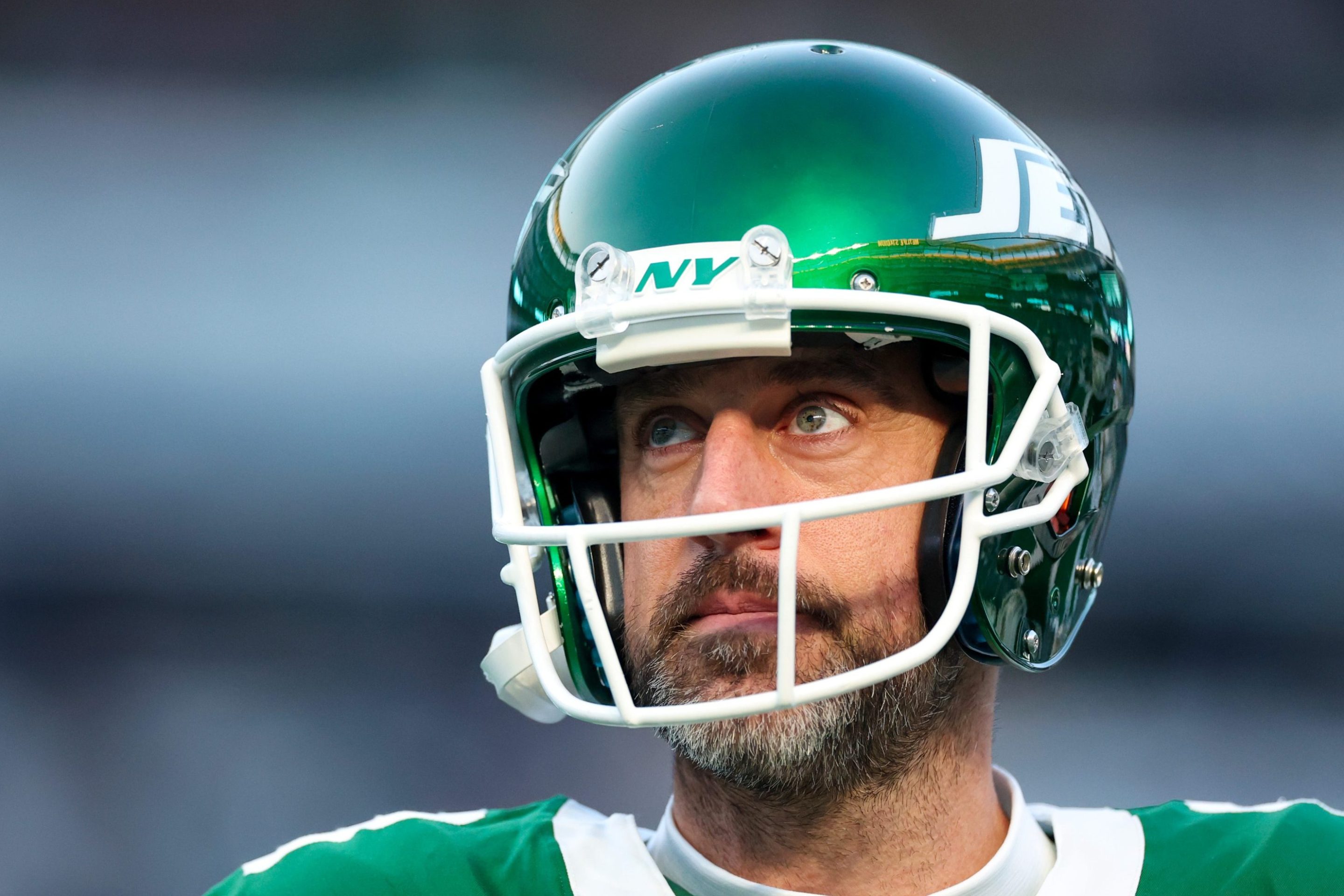 Aaron Rodgers #8 of the New York Jets looks on before the game against the Miami Dolphins at MetLife Stadium on January 05, 2025 in East Rutherford, New Jersey. The bags under his eyes are very, very large.