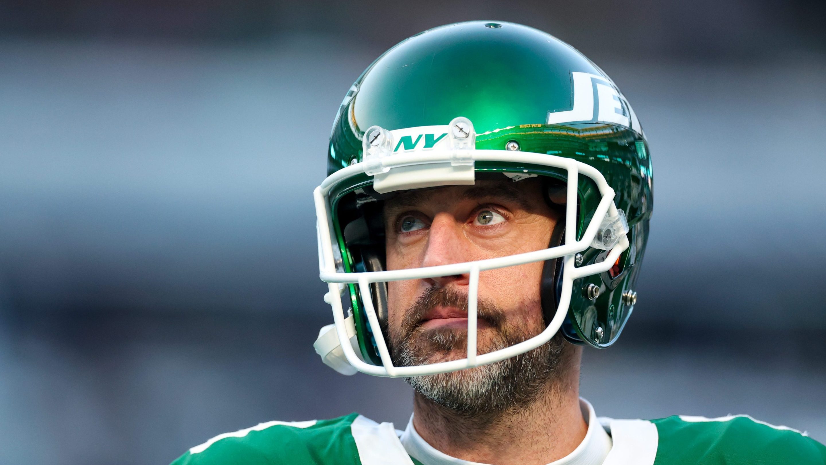 Aaron Rodgers #8 of the New York Jets looks on before the game against the Miami Dolphins at MetLife Stadium on January 05, 2025 in East Rutherford, New Jersey. The bags under his eyes are very, very large.