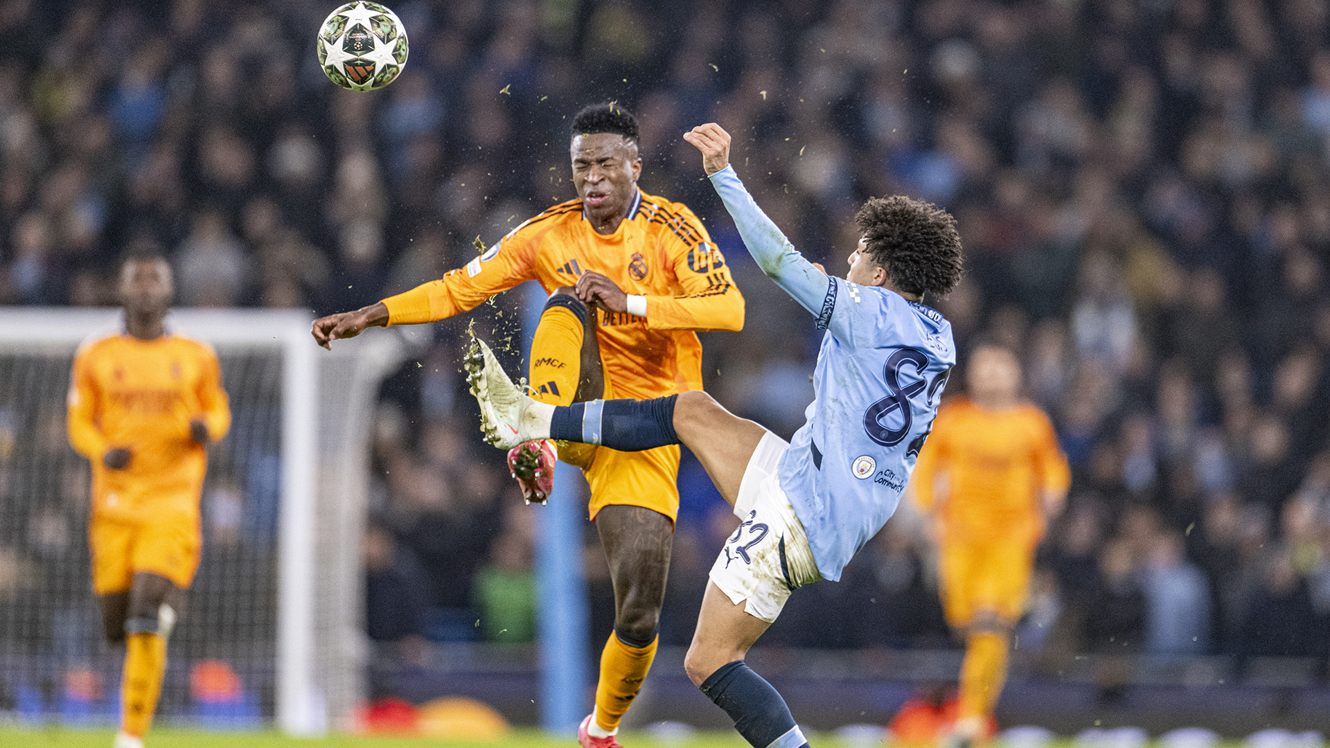 Vinícius Júnior of Real Madrid (L) and Rico Lewis of Manchester City (R) in dispute for possession during the UEFA Champions League 2024/25 League Knockout Play-off first leg match between Manchester City and Real Madrid C.F. at Manchester City Stadium on February 11, 2025 in Manchester, England.