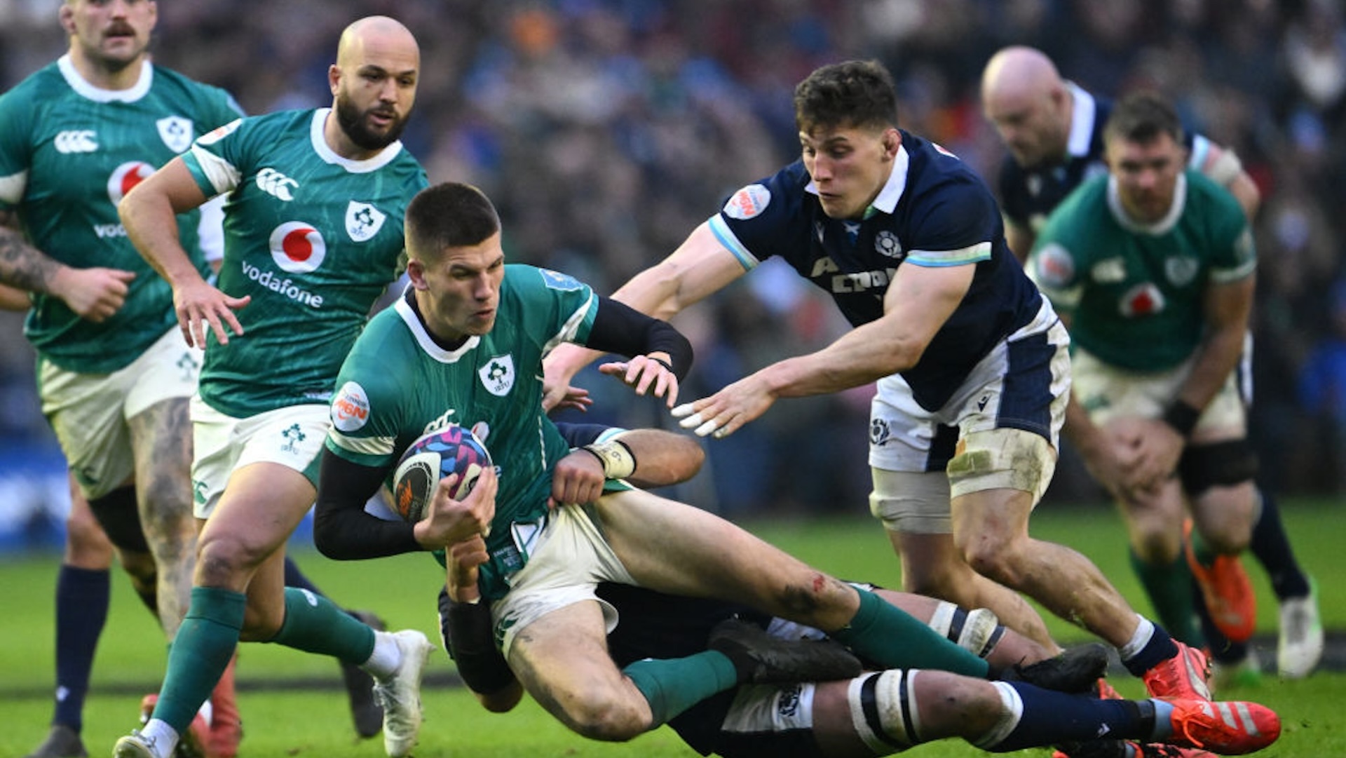 Sam Prendergast of Ireland is tackled by Matt Fagerson and Rory Darge of Scotland during the Guinness Six Nations 2025 match between Scotland and Ireland at Scottish Gas Murrayfield on February 09, 2025 in Edinburgh, Scotland.