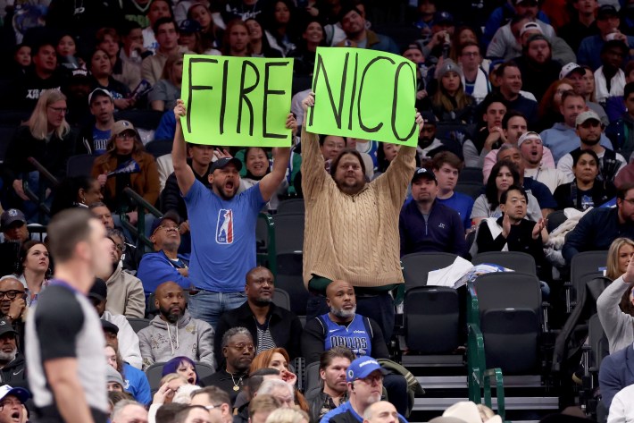 Fans hold up "Fire Nico" signs in Dallas, during a Mavericks loss.