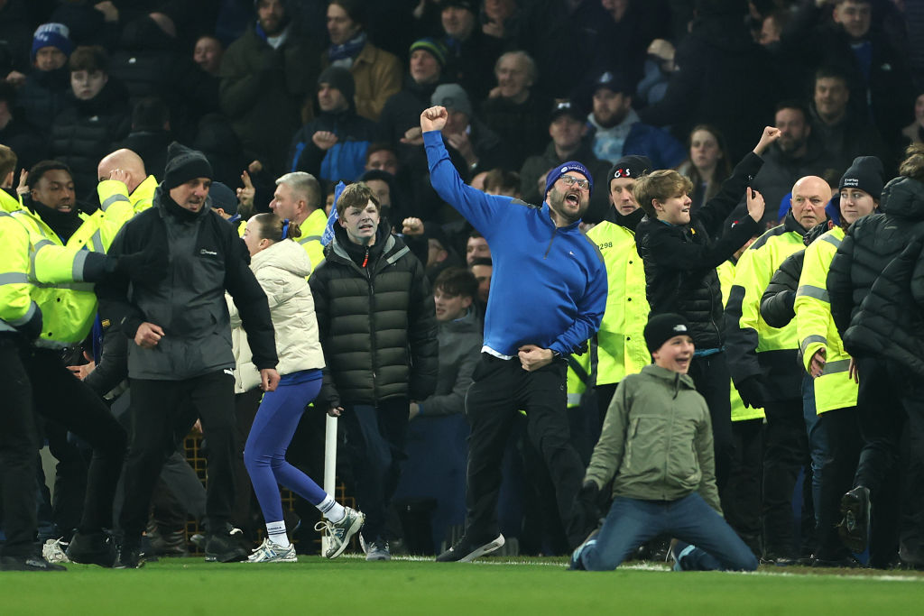 Everton supporters invade the pitch after James Tarkowski scores his sides second goal during the Premier League match between Everton FC and Liverpool FC at Goodison Park on February 12, 2025 in Liverpool, England.