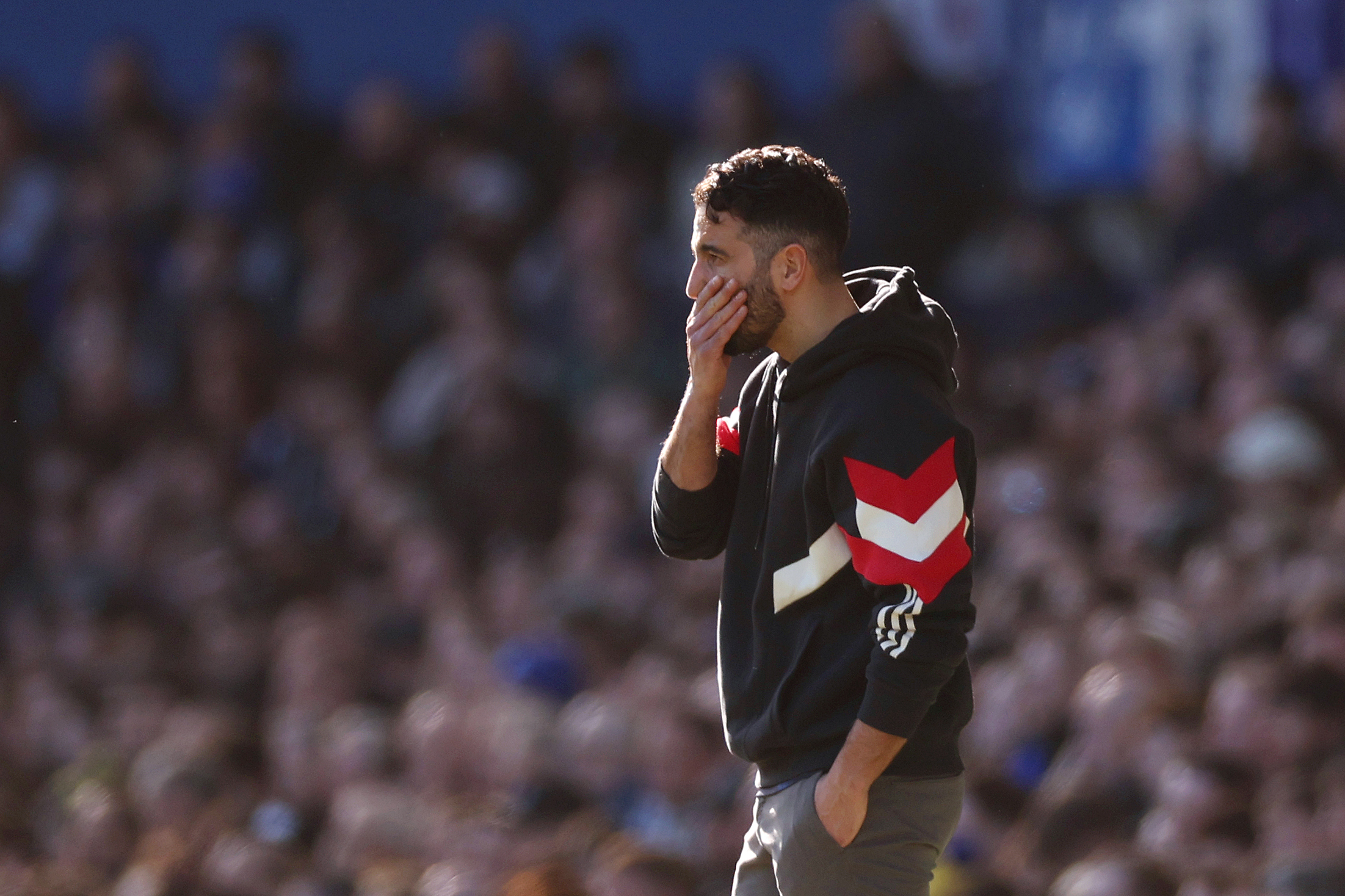 Ruben Amorim, Manager of Manchester United, reacts during the Premier League match between Everton FC and Manchester United FC at Goodison Park on February 22, 2025. He has his hand over his mouth and looks aghast.