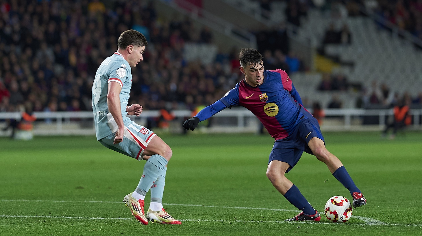 Pedro Gonzalez 'Pedri' of FC Barcelona competes for the ball with Julian Alvarez of Atletico de Madrid during the Copa del Rey semi-final Leg One match between FC Barcelona and Atletico de Madrid at Estadi Olimpic Lluis Companys on February 25, 2025 in Barcelona, Spain.