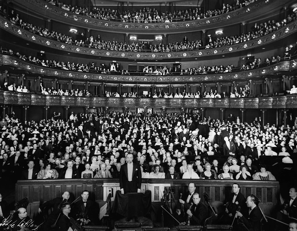 Interior of the Metropolitan Opera House, New York City, showing orchestra in foreground and audience in back