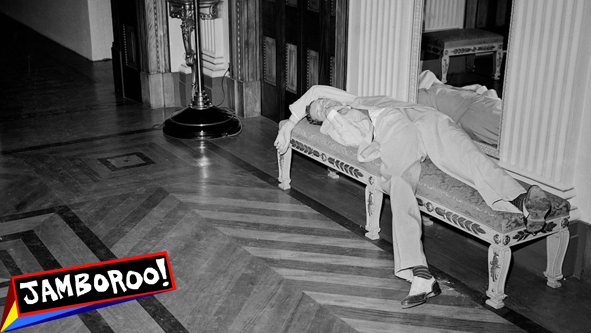 Man napping on lobby couch, ca. 1930