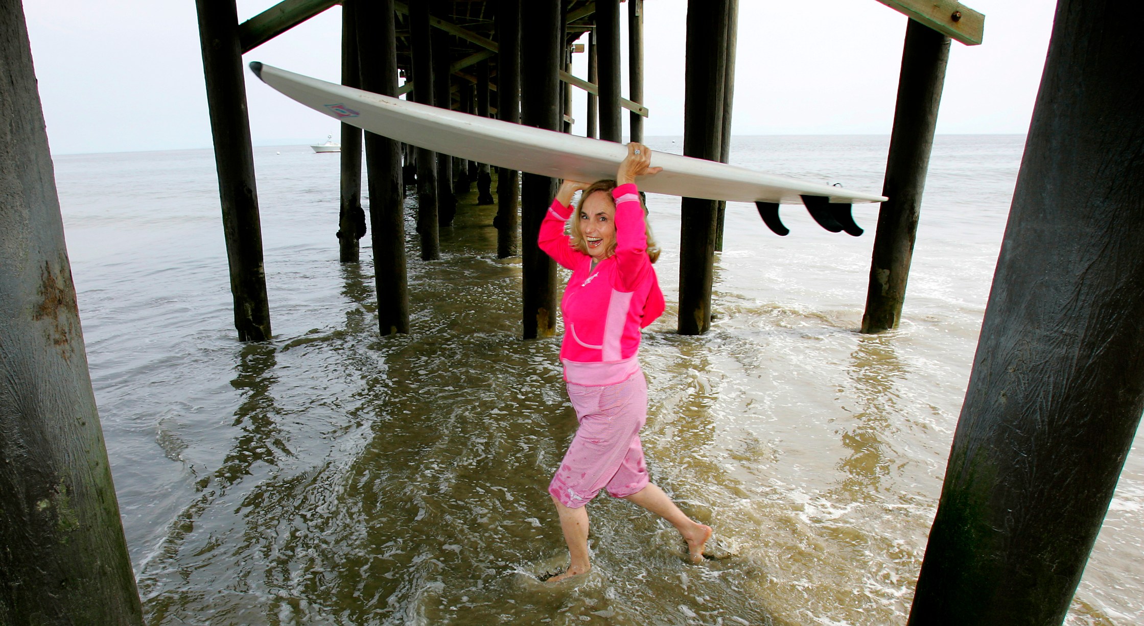 Photo of Gidget running through the Malibu Pier. Fifty years after Kathy Kohner Zuckerman, aka Gidget, learned to surf in Malibu, the surfing world has accepted her as surfing's early pioneers, mascots and avid promoters. April 27, 2006, (Photo by Ken Hively/Los Angeles Times via Getty Images)