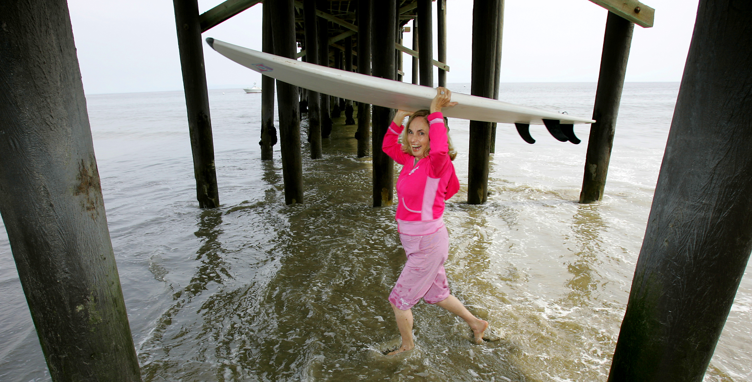 Photo of Gidget running through the Malibu Pier. Fifty years after Kathy Kohner Zuckerman, aka Gidget, learned to surf in Malibu, the surfing world has accepted her as surfing's early pioneers, mascots and avid promoters. April 27, 2006, (Photo by Ken Hively/Los Angeles Times via Getty Images)