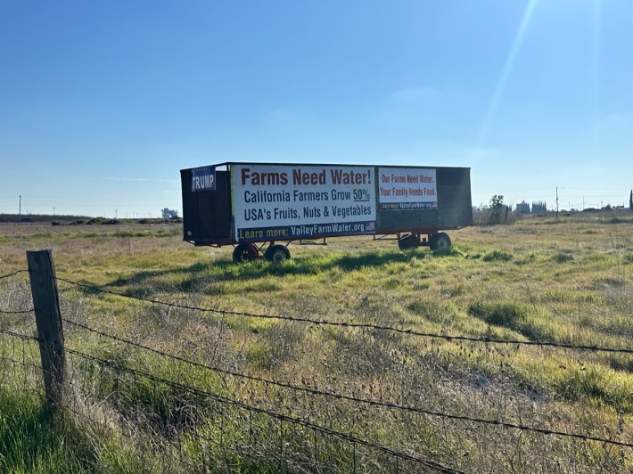 A roadside sign that says Farms Need Water!