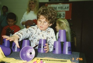 The author stacking cups as a child.