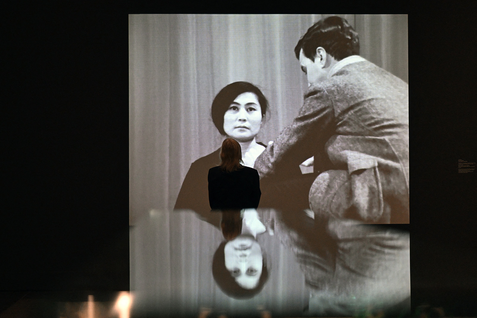 A woman stands in front of the Yoko Ono, »Cut Piece«, 1965, during a press preview at the Kunstsammlung Nordrhein-Westfalen in Duesseldorf, western Germany on September 26, 2024. In cooperation with the Tate Modern, the Kunstsammlung Nordrhein-Westfalen is presenting the influential work of artist and activist Yoko Ono in a comprehensive solo exhibition taking place from September 28, 2024 to March 6, 2025.