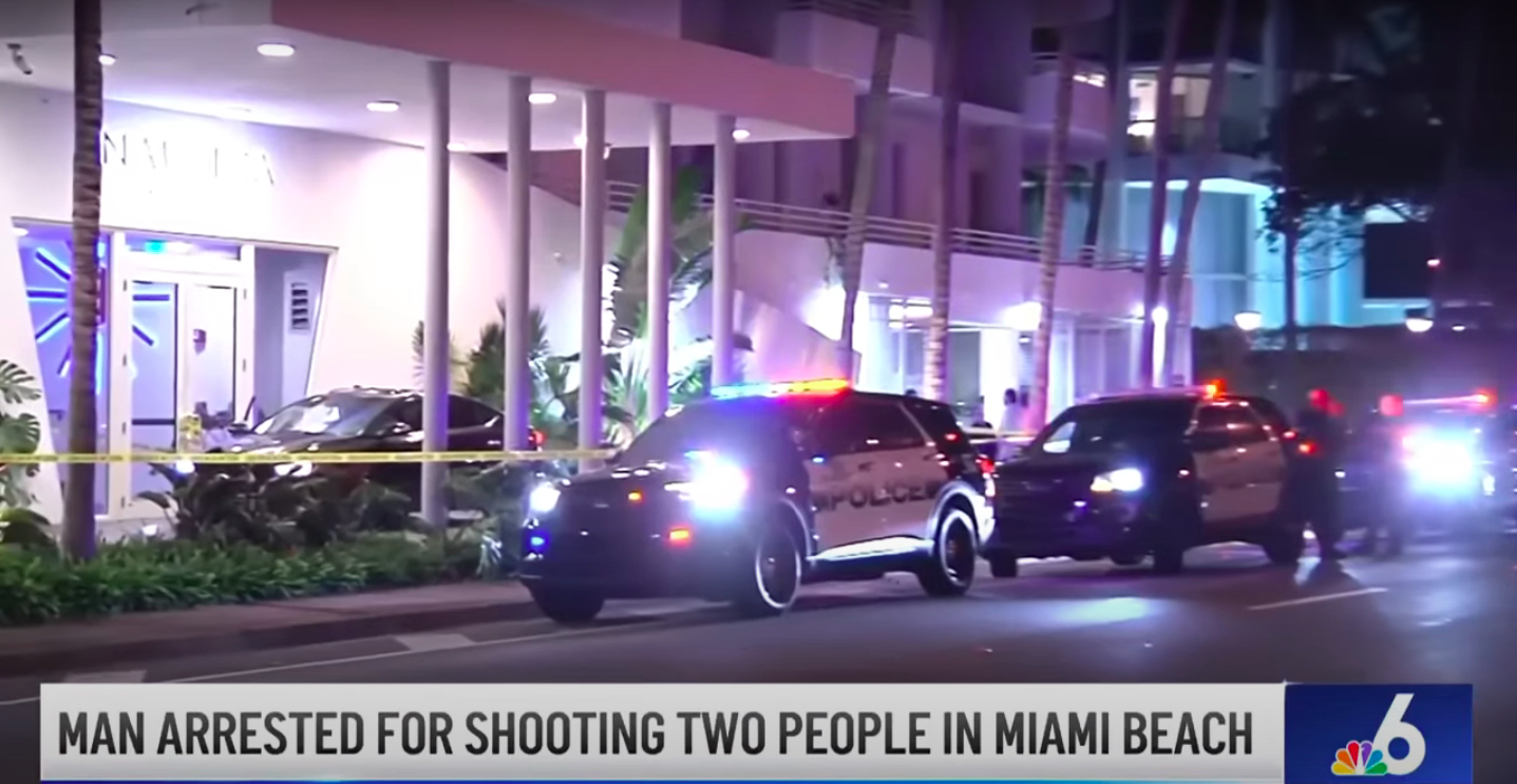 A news chyron that reads: Man arrested for shooting two people in Miami Beach