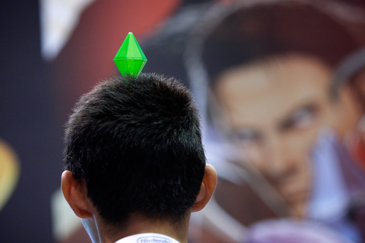 A gamer wears a gem head decoration that was handed out at the SIMS exhibit in the annual Electronic Entertainment Expo (E3) at the Los Angeles Convention Center on June 16, 2010 in Los Angeles, California.