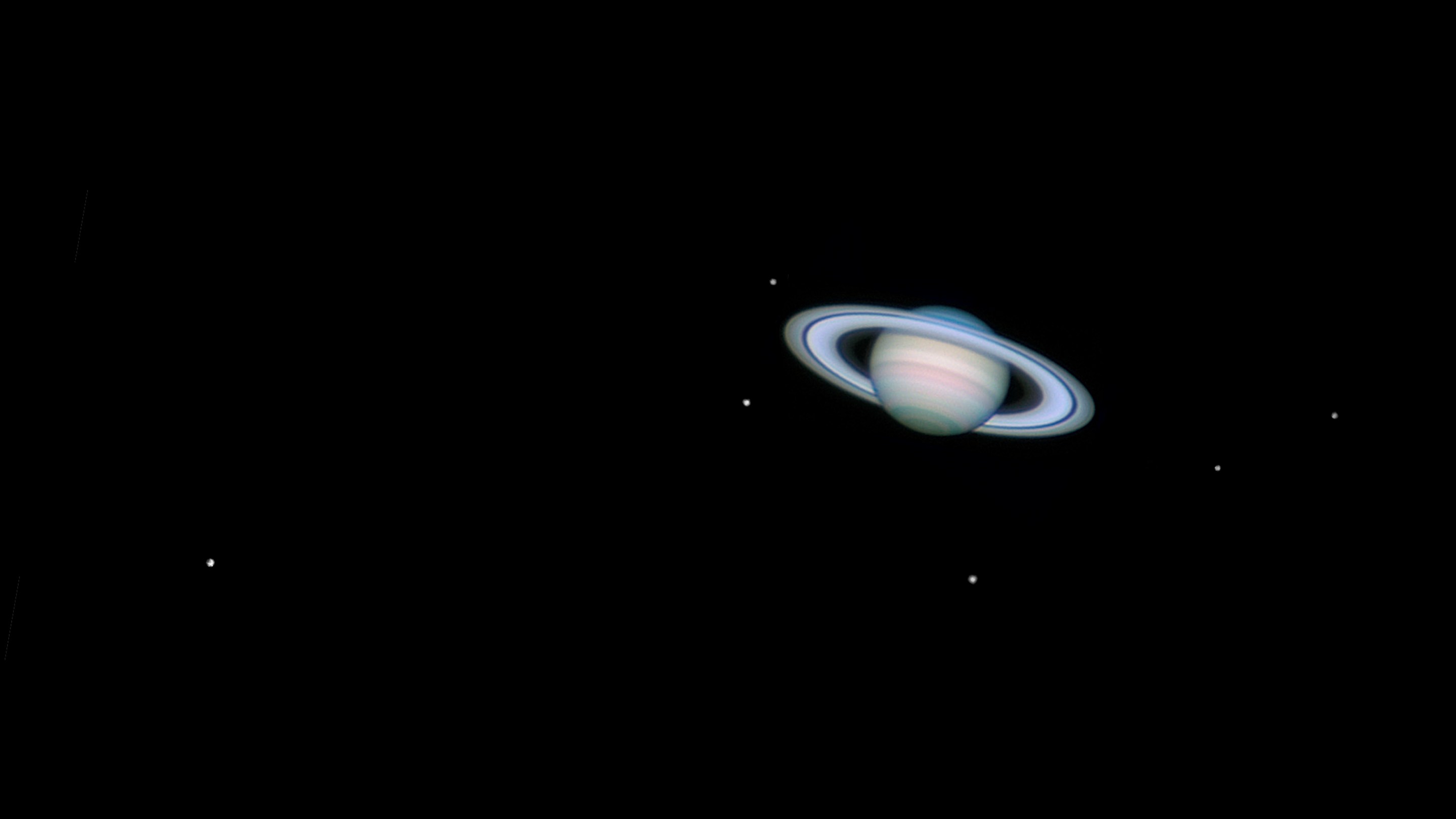 UNITED KINGDOM - MAY 30: Saturn, by Jamie Cooper. This image showing Saturn with six of it's moons was taken on 26th January 2006 at 22:11 hrs UT using a webcam attached to a 14 inch Schmidt-Cassegrain telescope. The moons are from left to right: Titan, Mimas,Tethys, Rhea, Enceladus and Dione. (Photo by Jamie Cooper/SSPL/Getty Images)