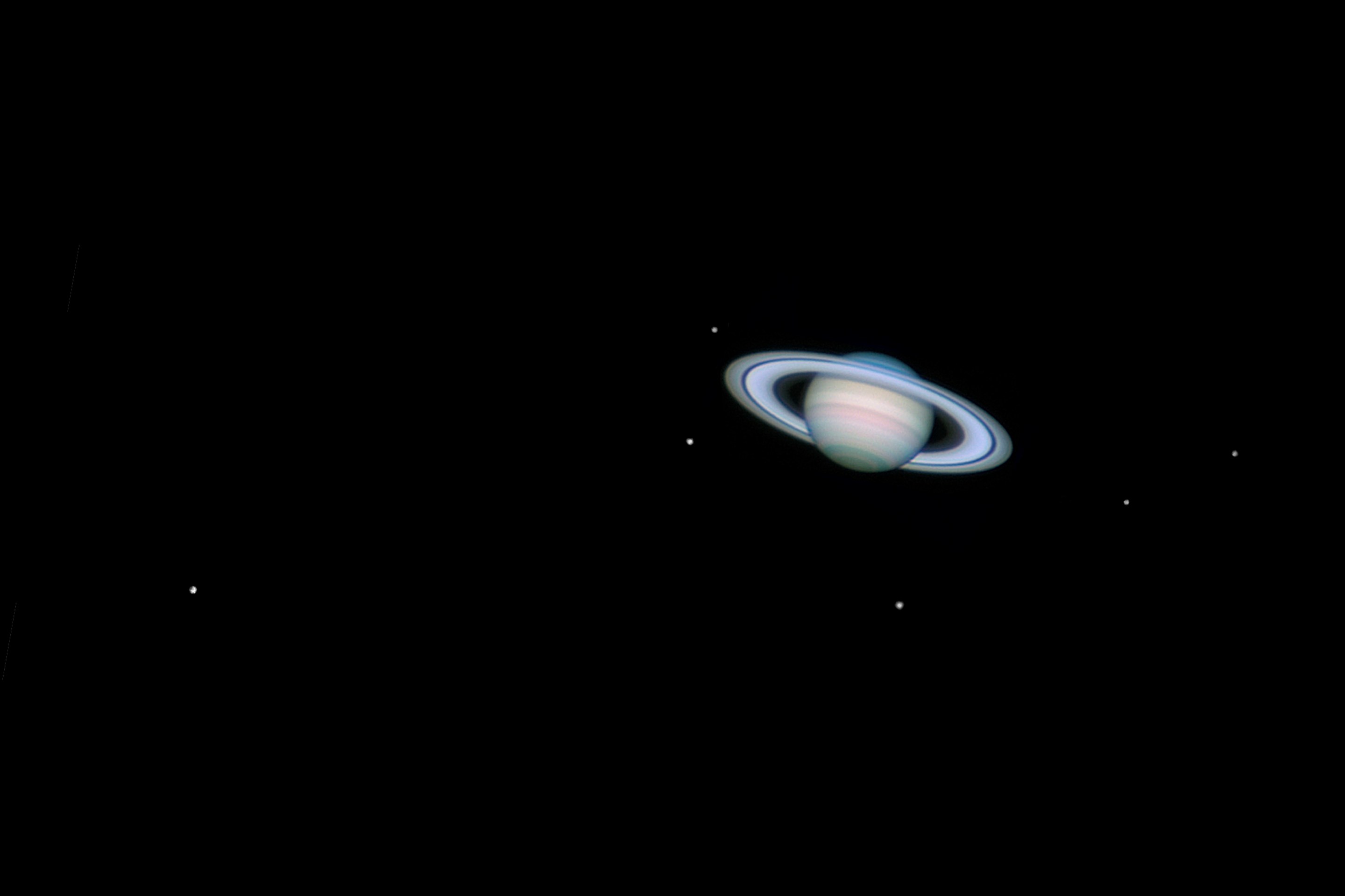 UNITED KINGDOM - MAY 30: Saturn, by Jamie Cooper. This image showing Saturn with six of it's moons was taken on 26th January 2006 at 22:11 hrs UT using a webcam attached to a 14 inch Schmidt-Cassegrain telescope. The moons are from left to right: Titan, Mimas,Tethys, Rhea, Enceladus and Dione. (Photo by Jamie Cooper/SSPL/Getty Images)
