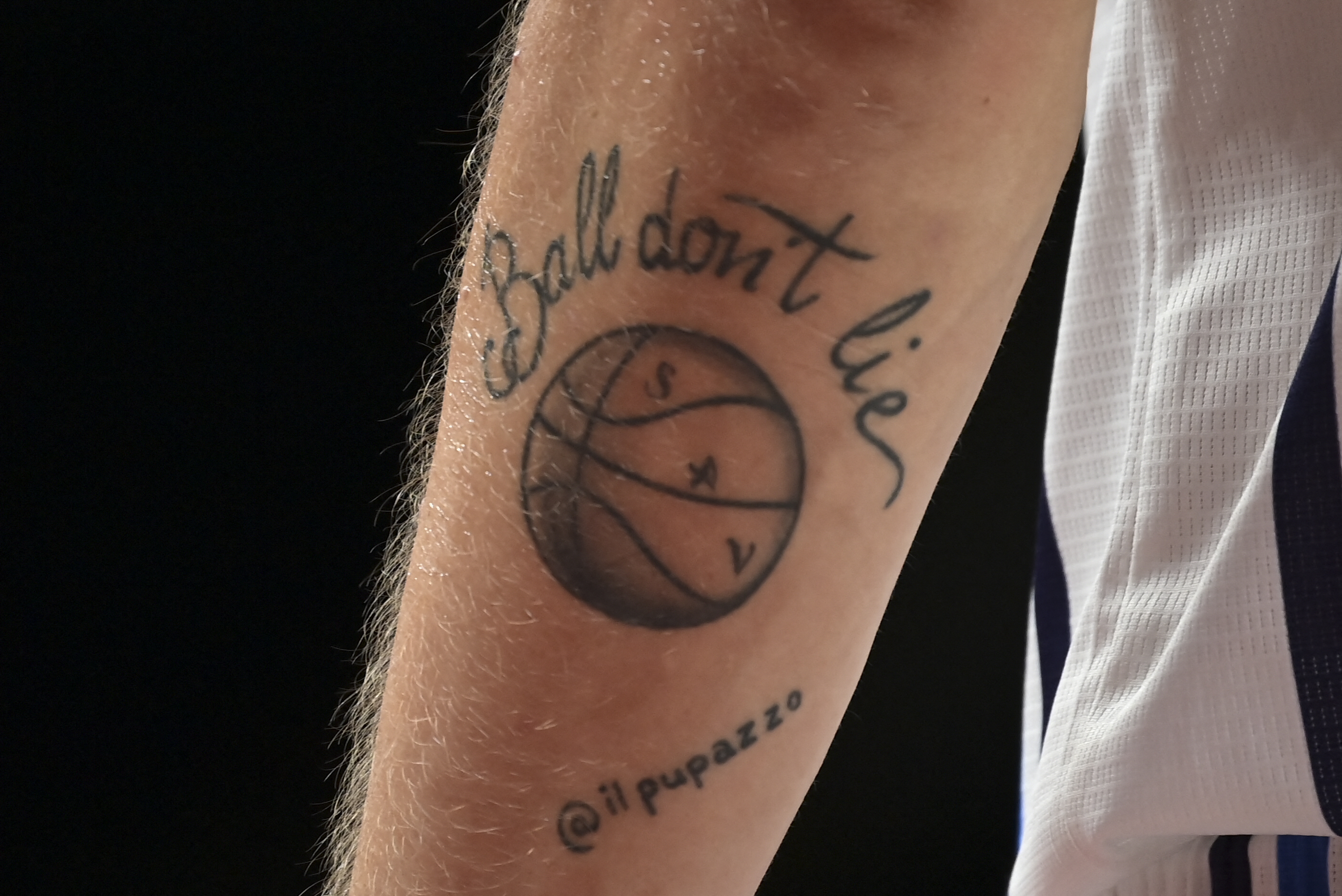 A tattoo that reads "Ball don't lie"