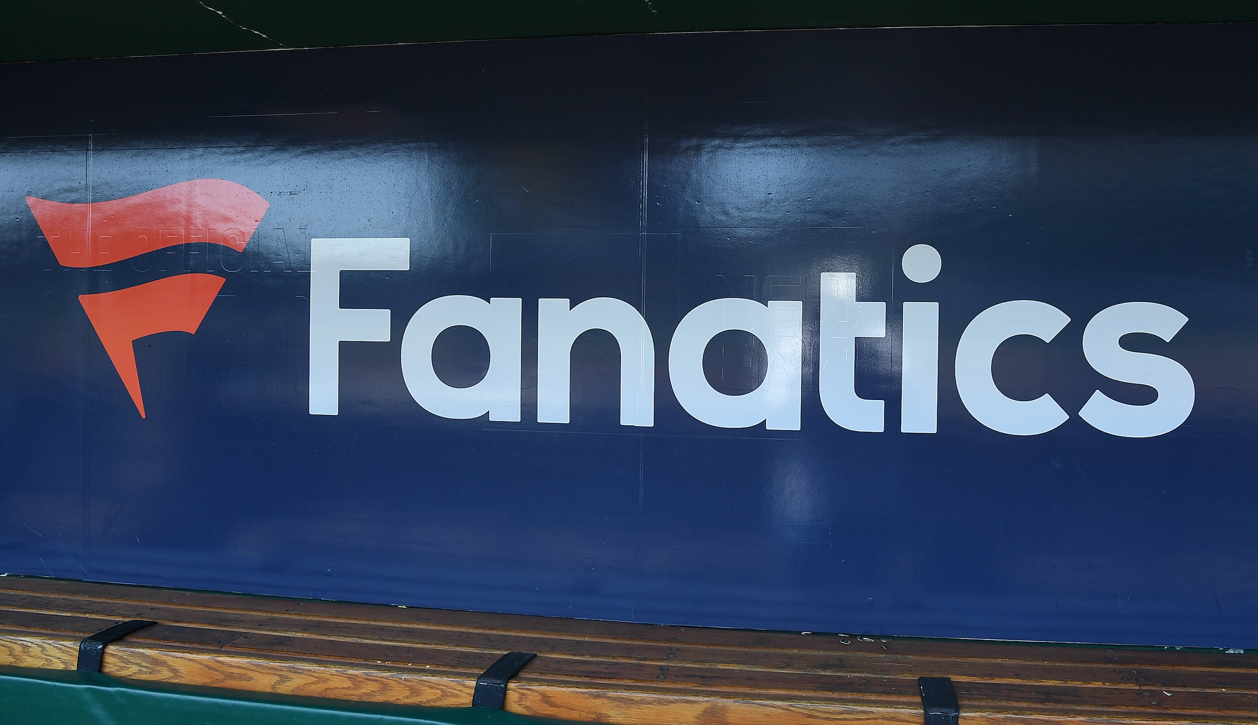 The Fanatics logo in a baseball dugout